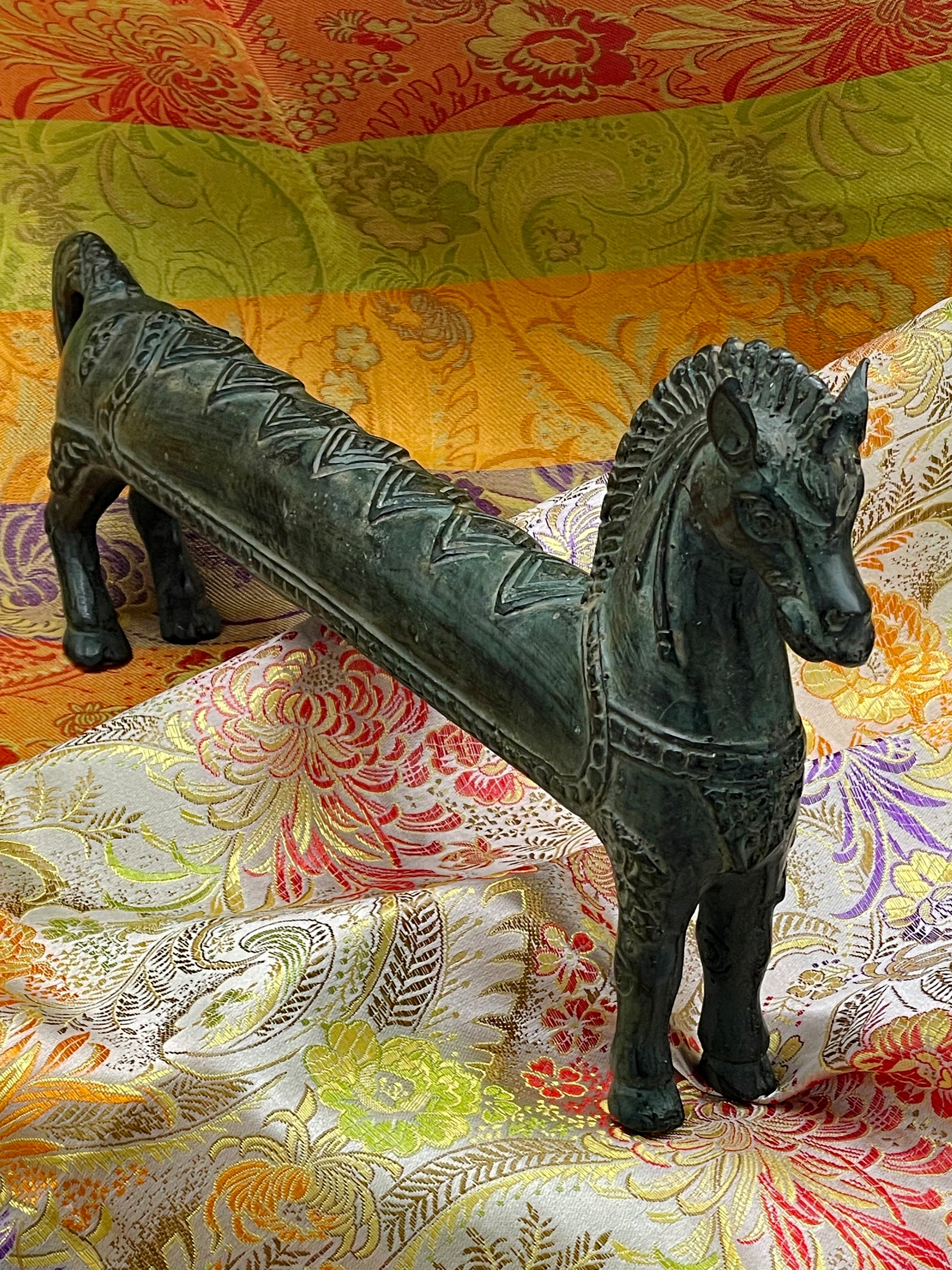 Three-quarter view of the bronze horse with arched neck and flowing mane