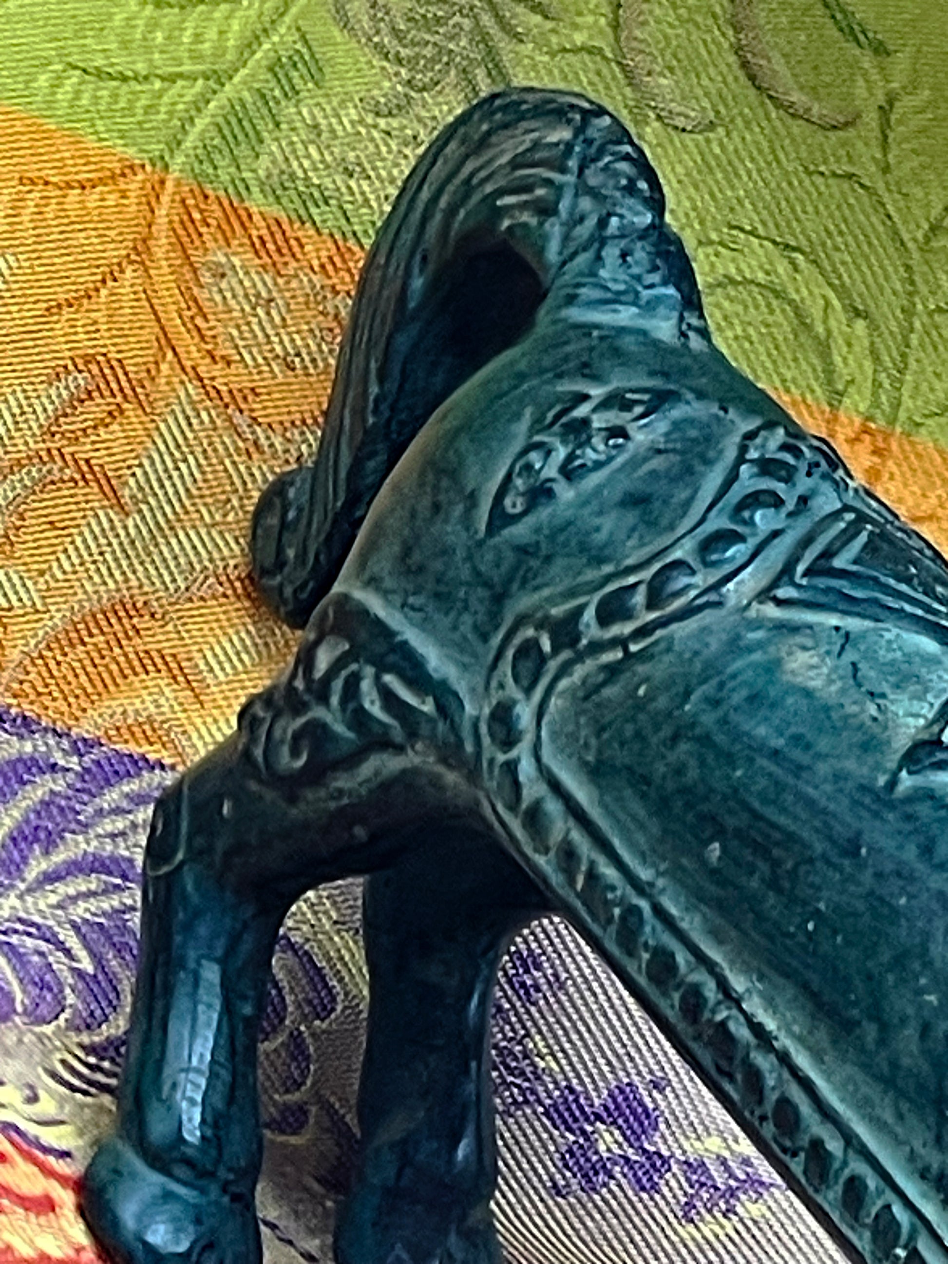 Detail of the incised saddle blanket and folk decoration on the body