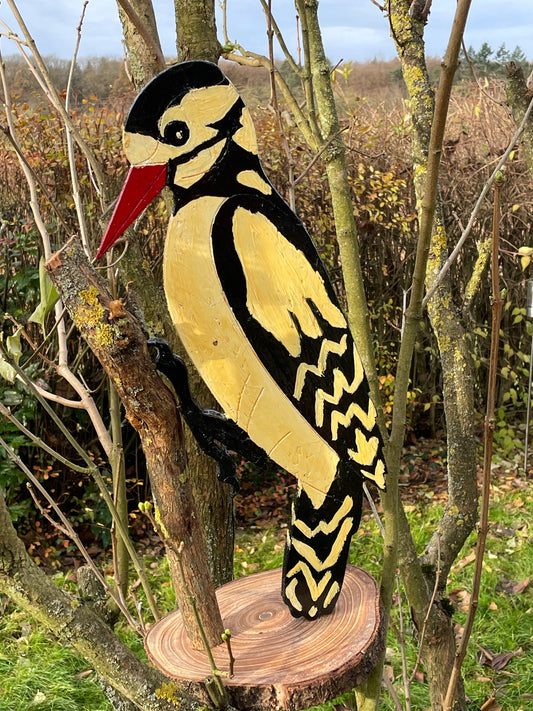 Hand-carved hand-painted wooden woodpecker folk-art sculpture on log base, full profile