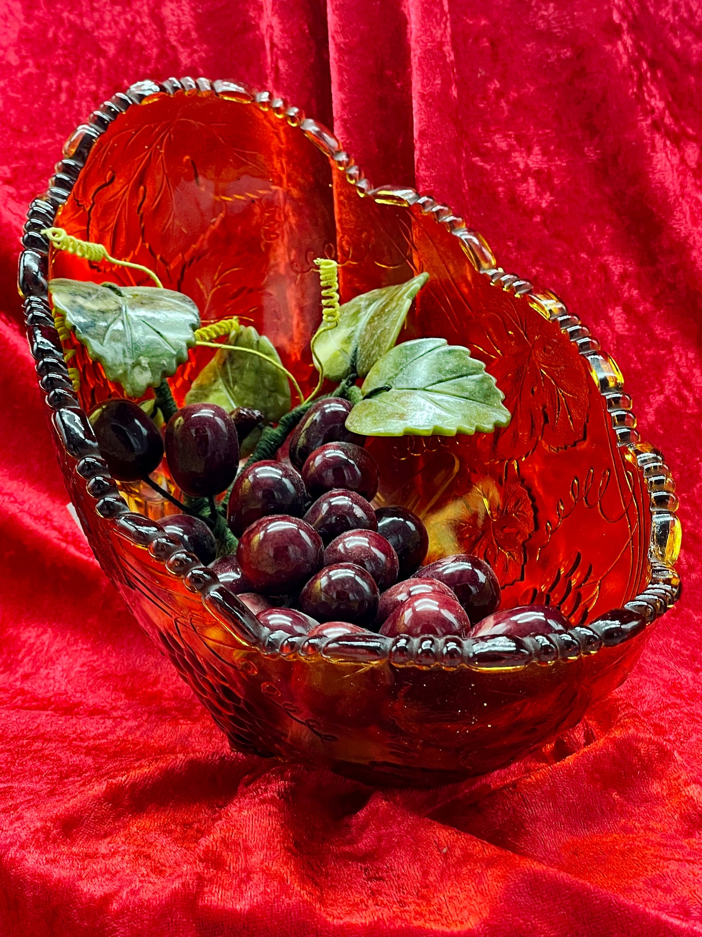 Amber art glass grape bowl with carved amethyst and jade grape cluster, front view