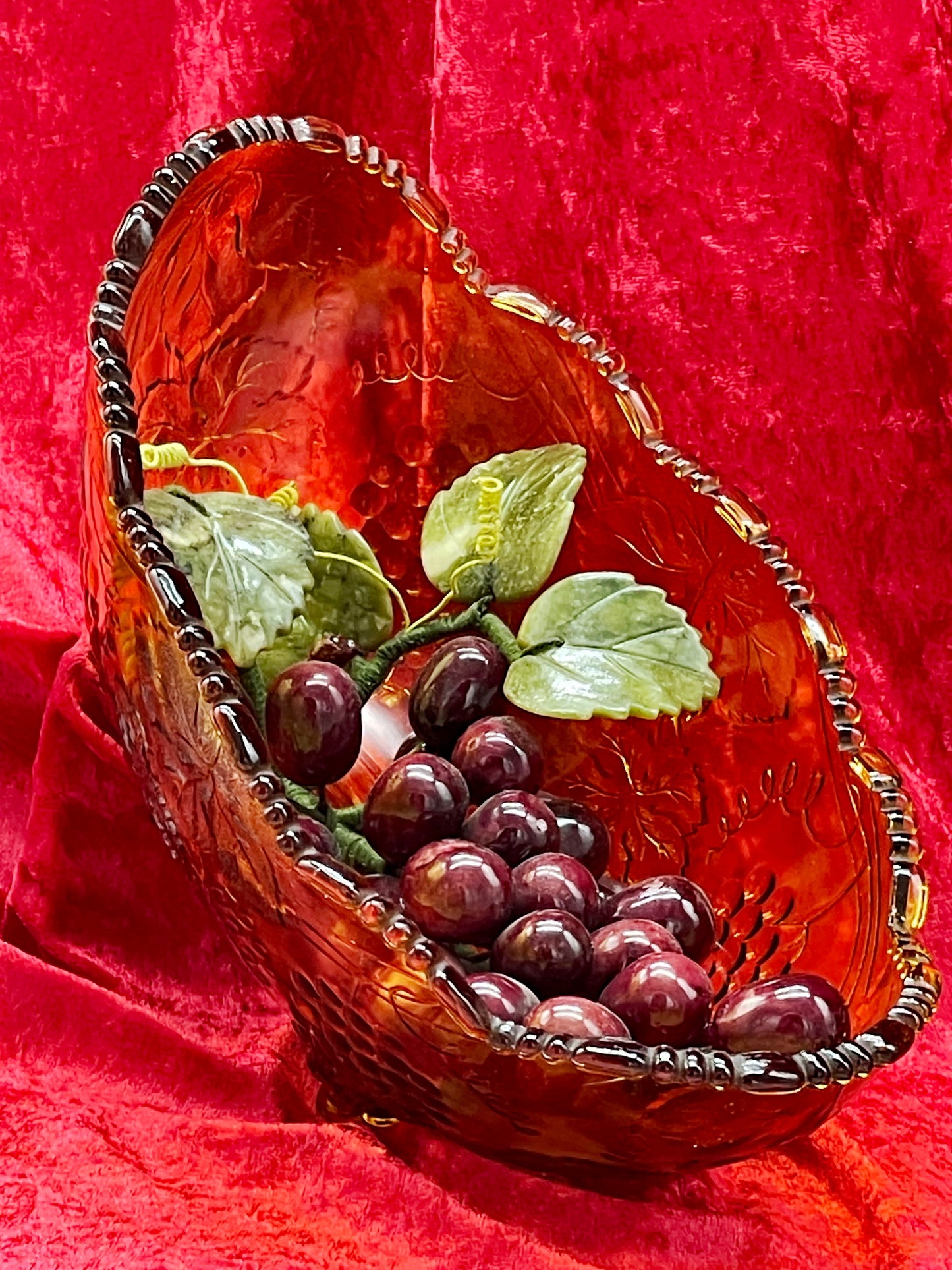 Side profile of the boat shaped amber pressed glass bowl with beaded rim