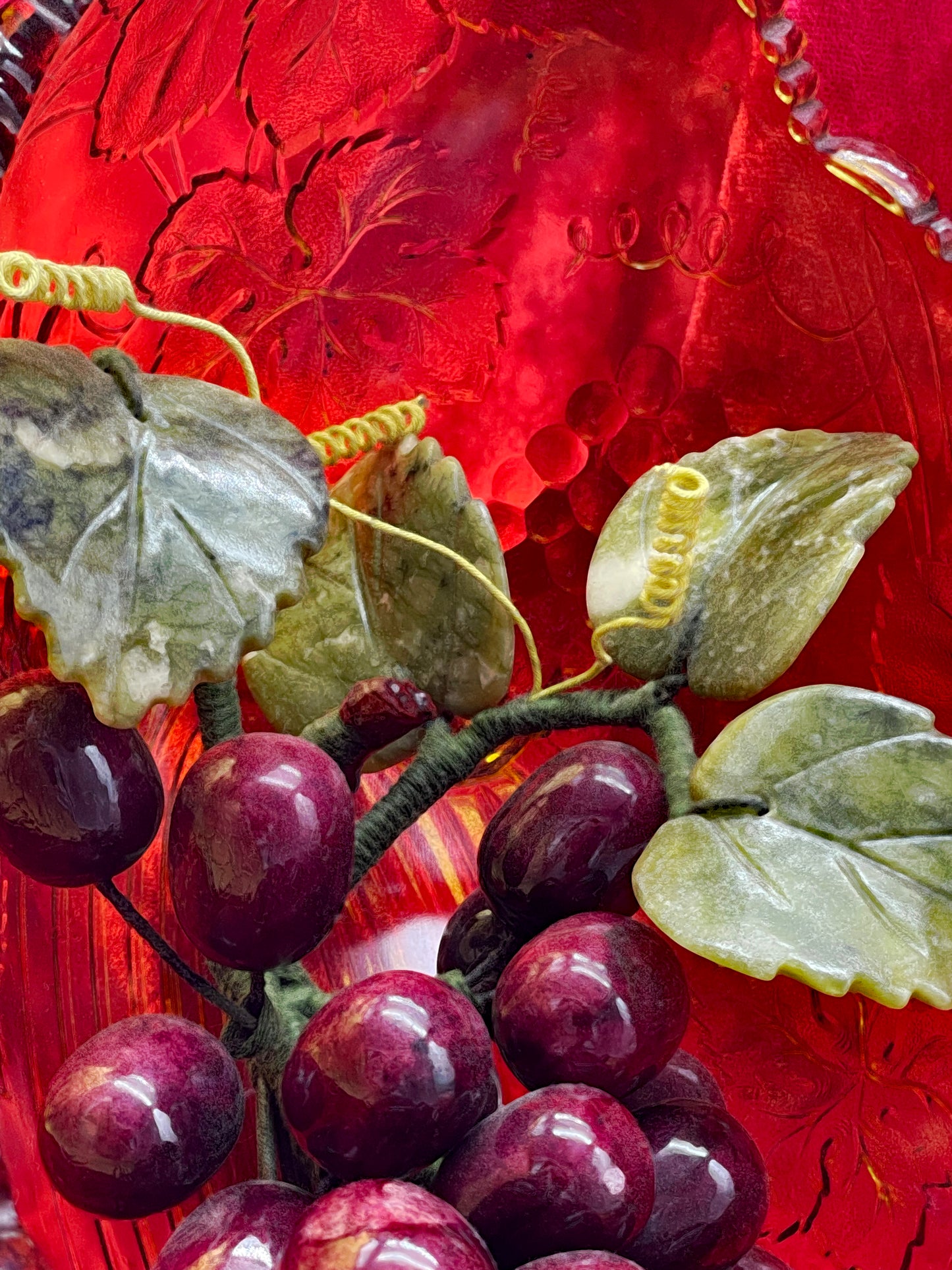 Detail of carved jade leaves, wire tendrils and amethyst grapes
