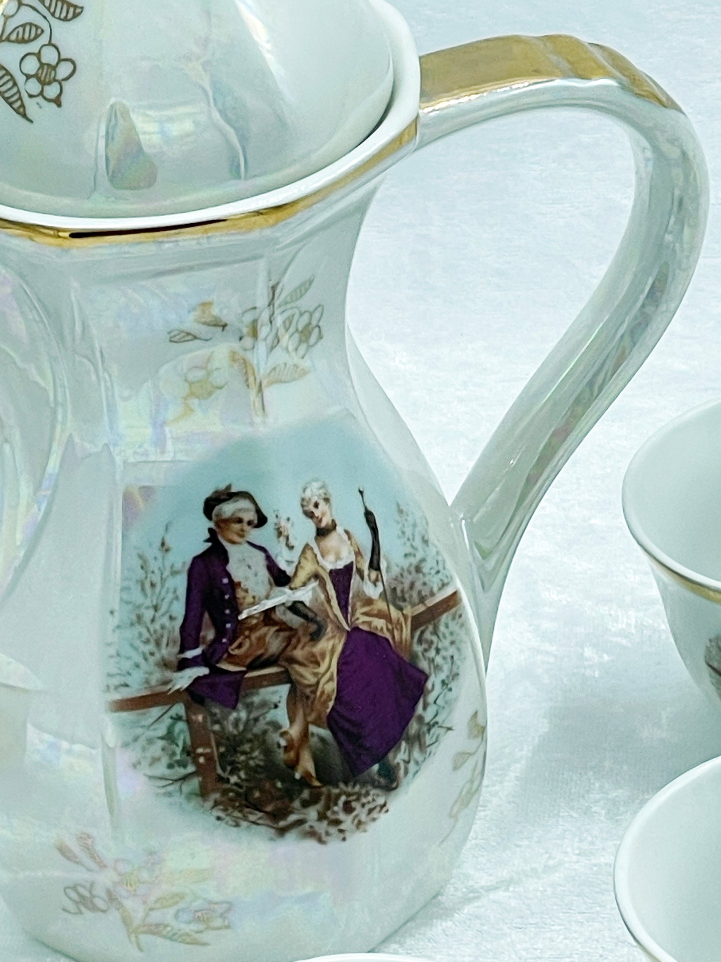 Iridescent lustreware coffee pot with Fragonard courting couple and gilt trim