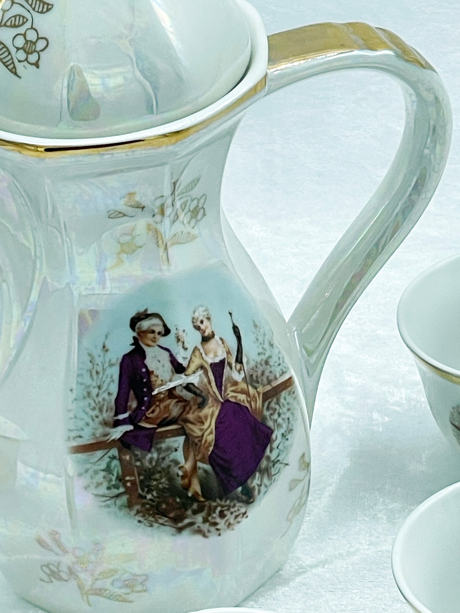 Iridescent lustreware coffee pot with Fragonard courting couple and gilt trim