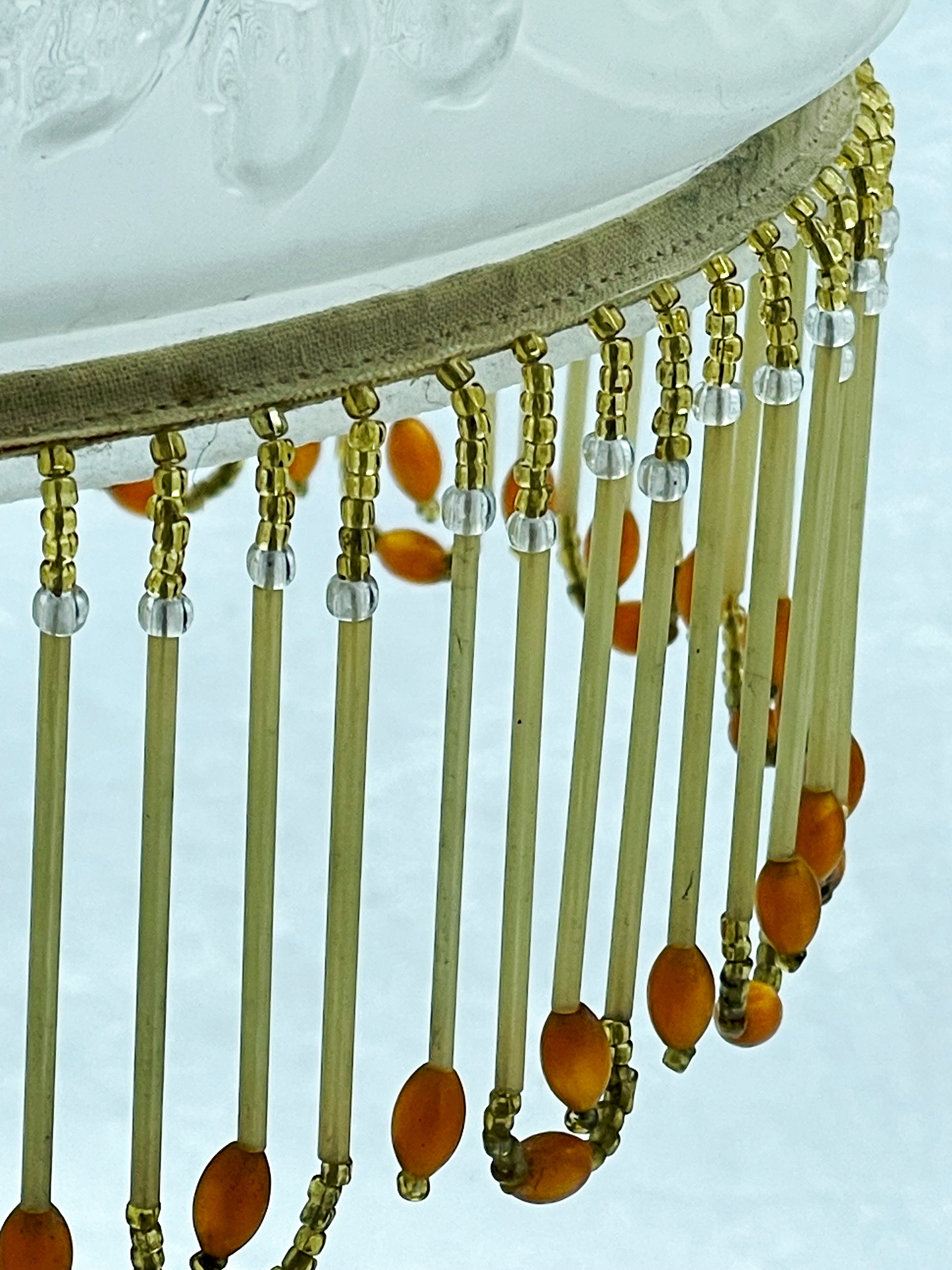Close view of the glass bugle bead fringe with amber drops