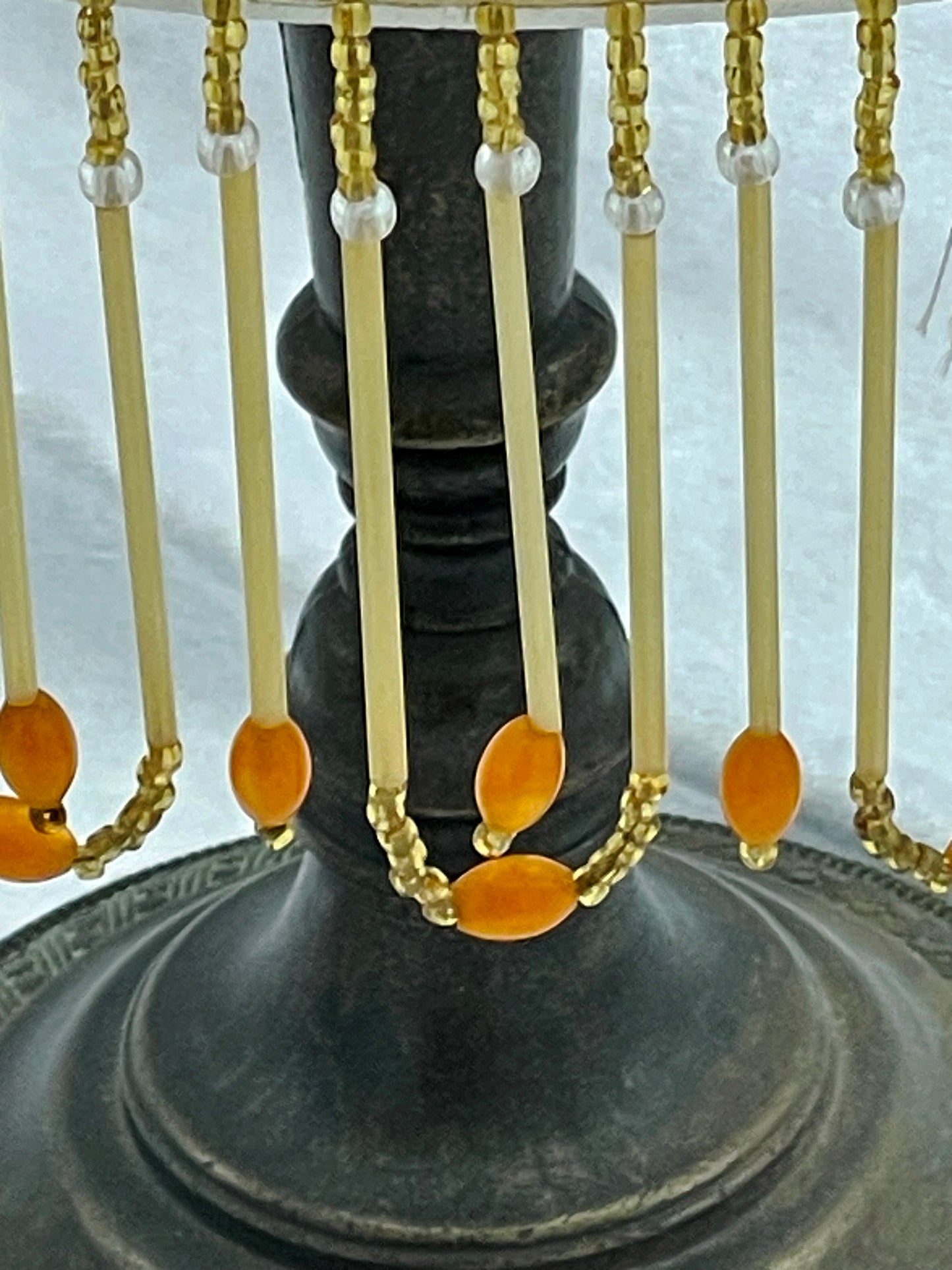 Cast metal stem and base of the vintage lamp with amber beaded fringe