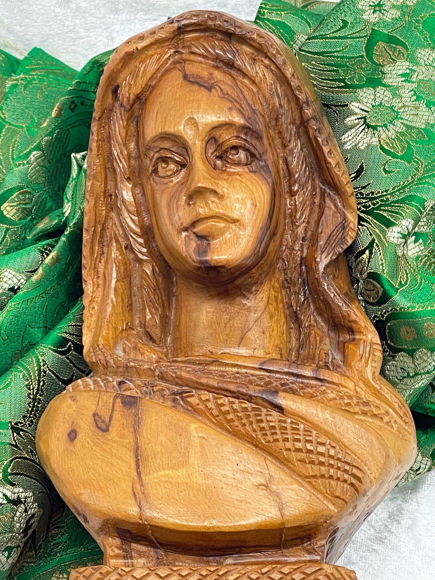Detail of face and draped sari with fine basket-weave shawl carving