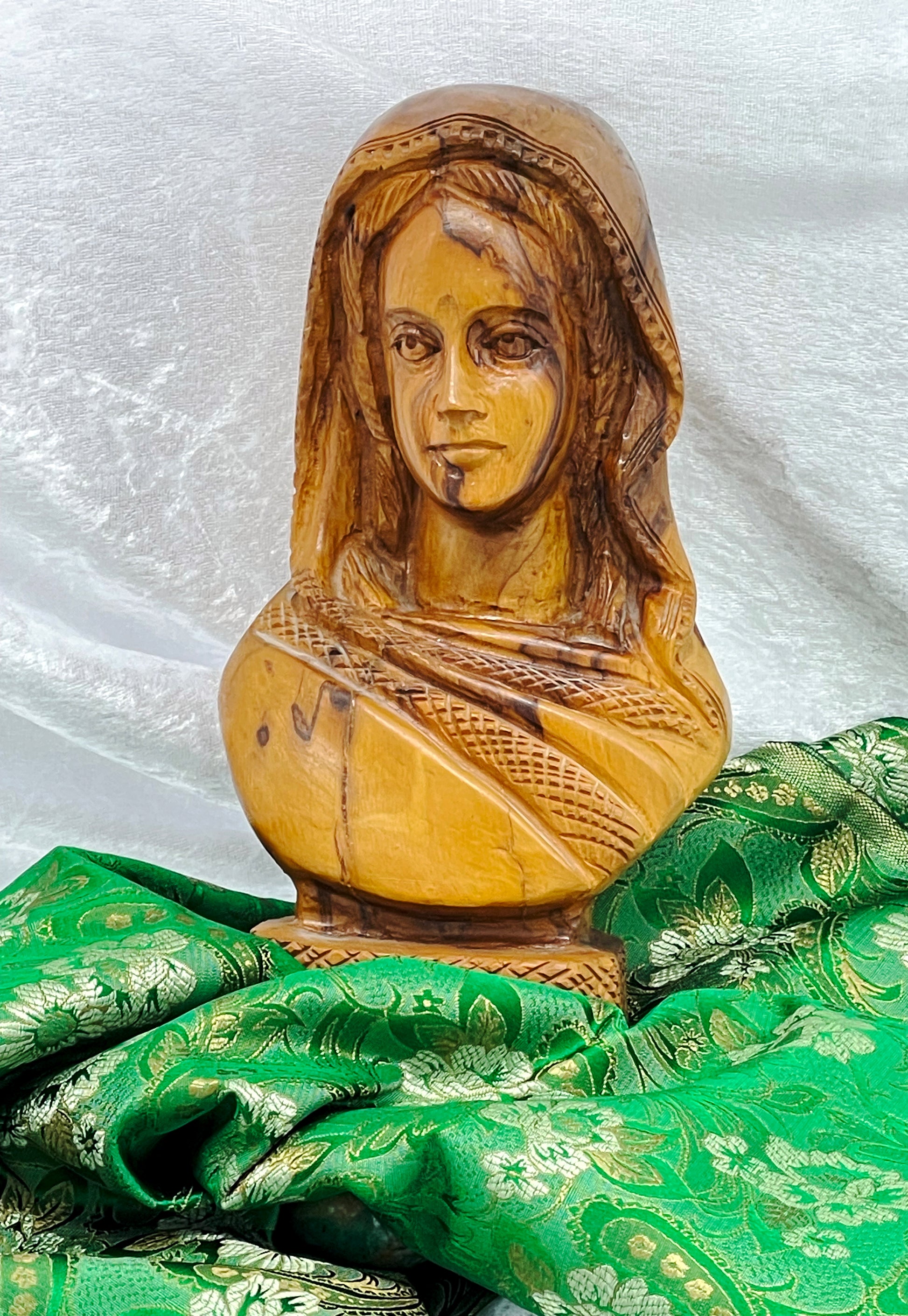 Three-quarter view of carved Indian woman sculpture in figured exotic hardwood