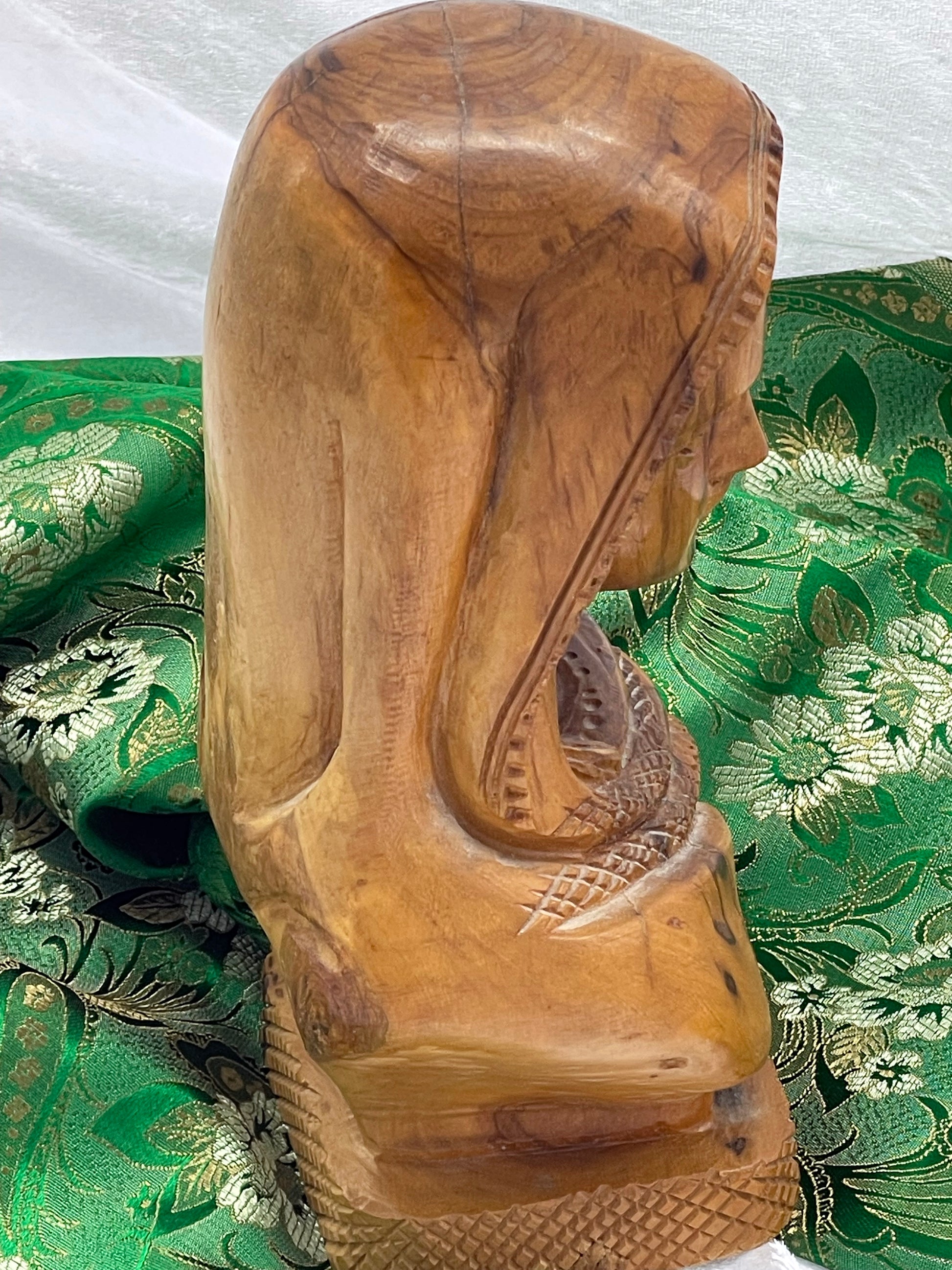 Side and rear view showing carved braid, draped shawl and natural wood grain