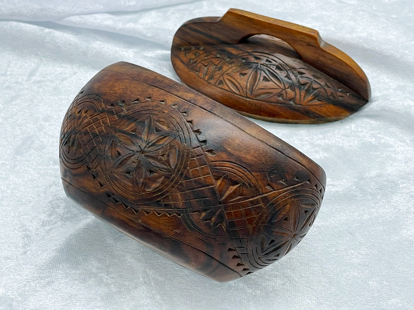 Close-up of the geometric chip-carved rosette and lattice band on the box body and lid