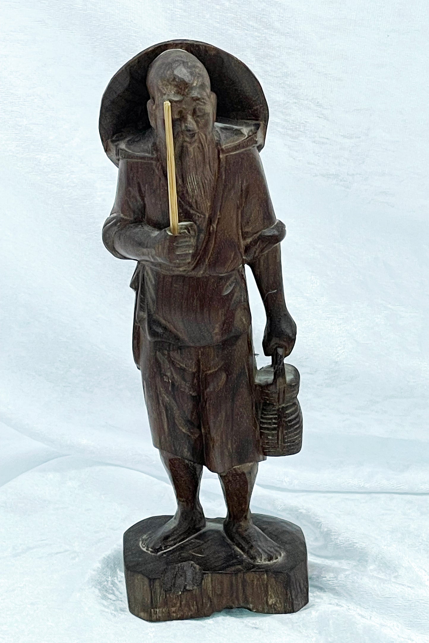 Hand-carved Chinese hardwood figure of an elderly sage fisherman, full front view on white