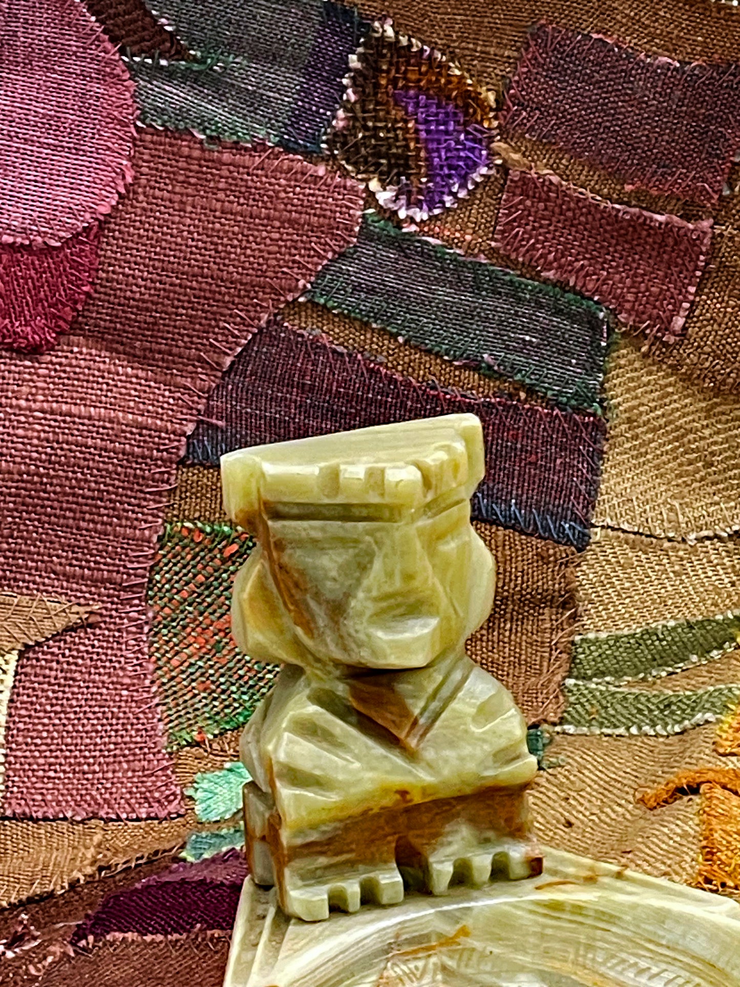 Detail of carved foot and natural onyx banding on the marble base