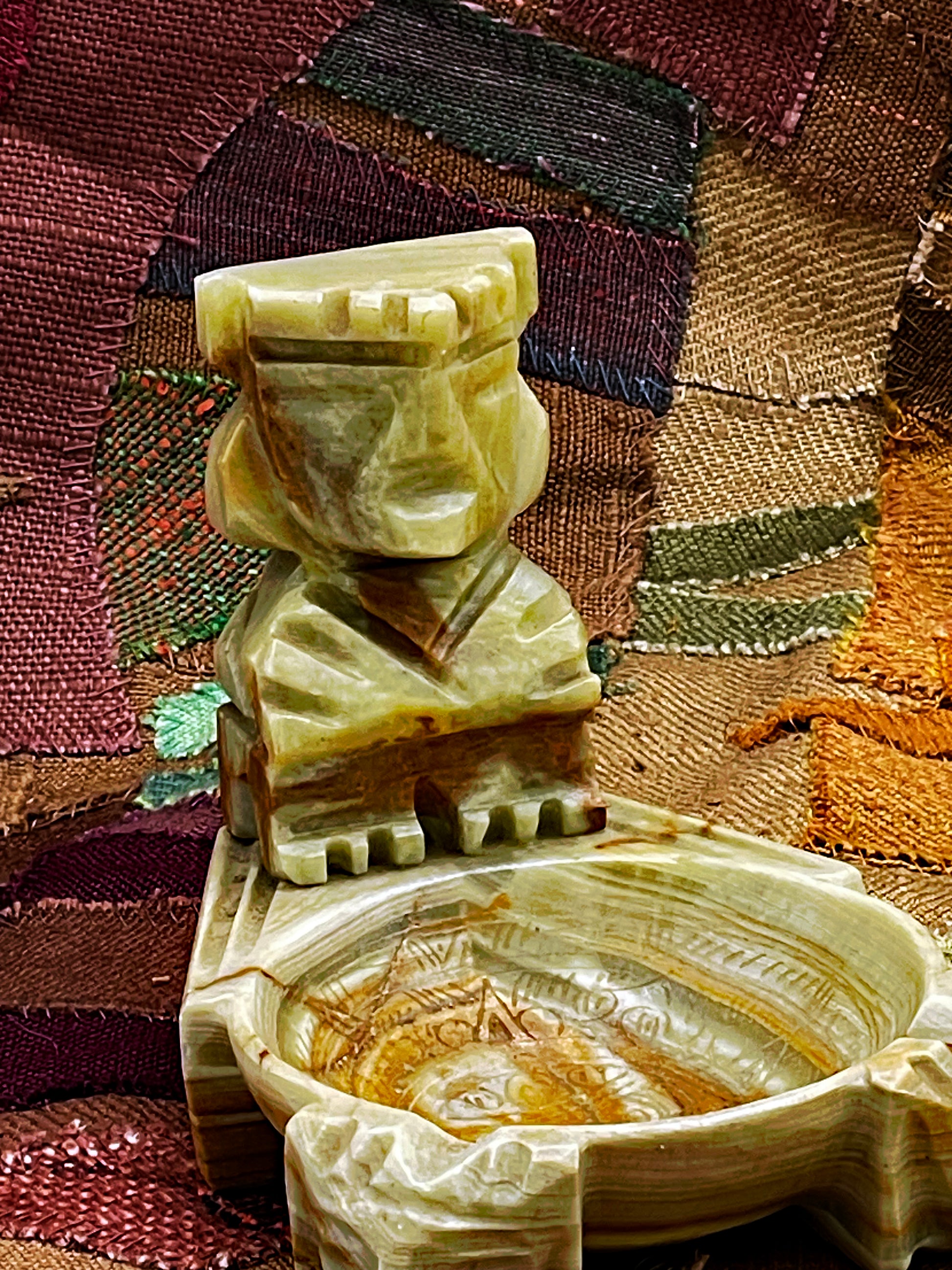 Mexican banded onyx marble ashtray with carved Aztec figure, three-quarter view