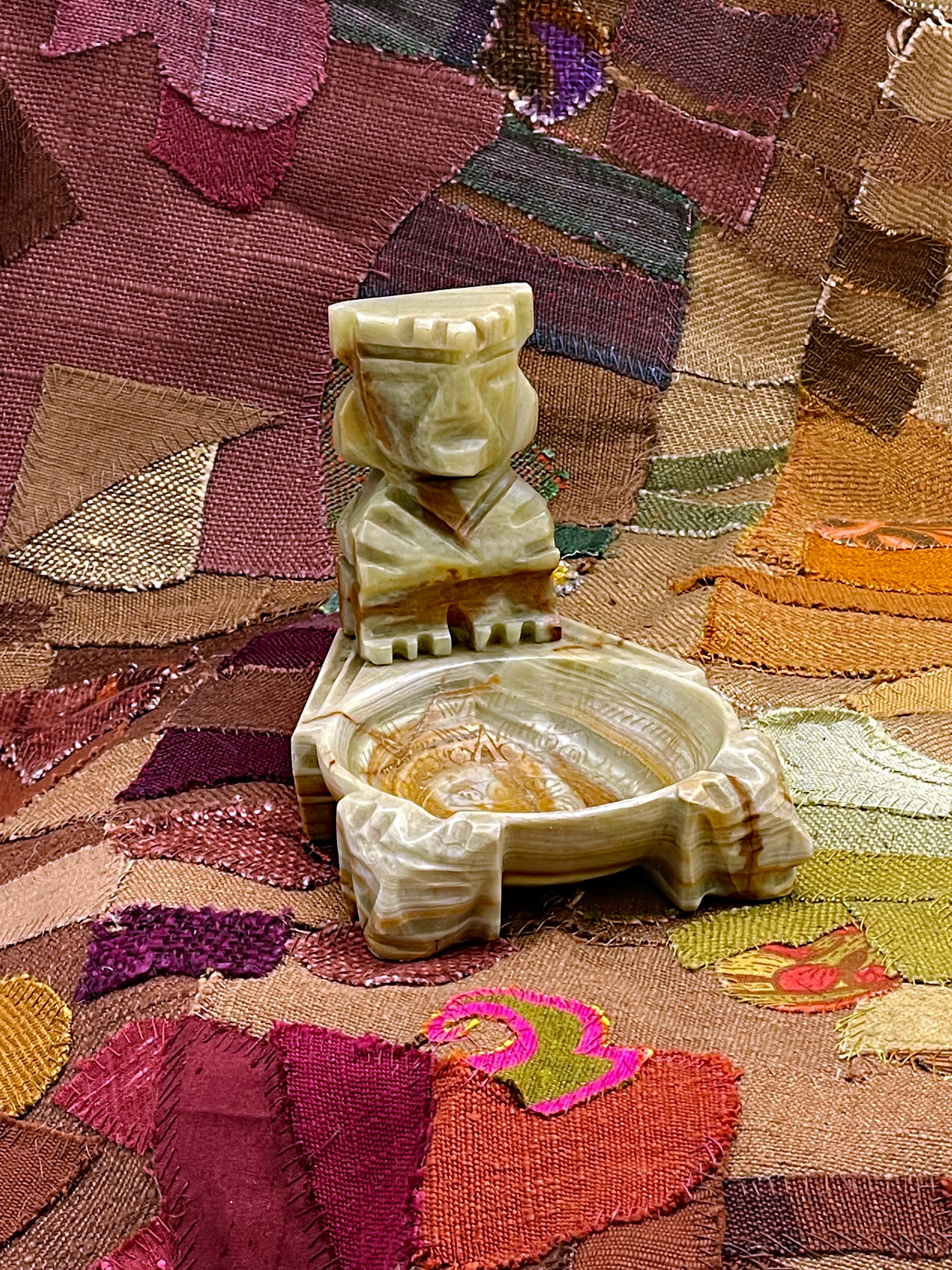 Vintage hand-carved onyx Aztec ashtray with seated deity figure, front view