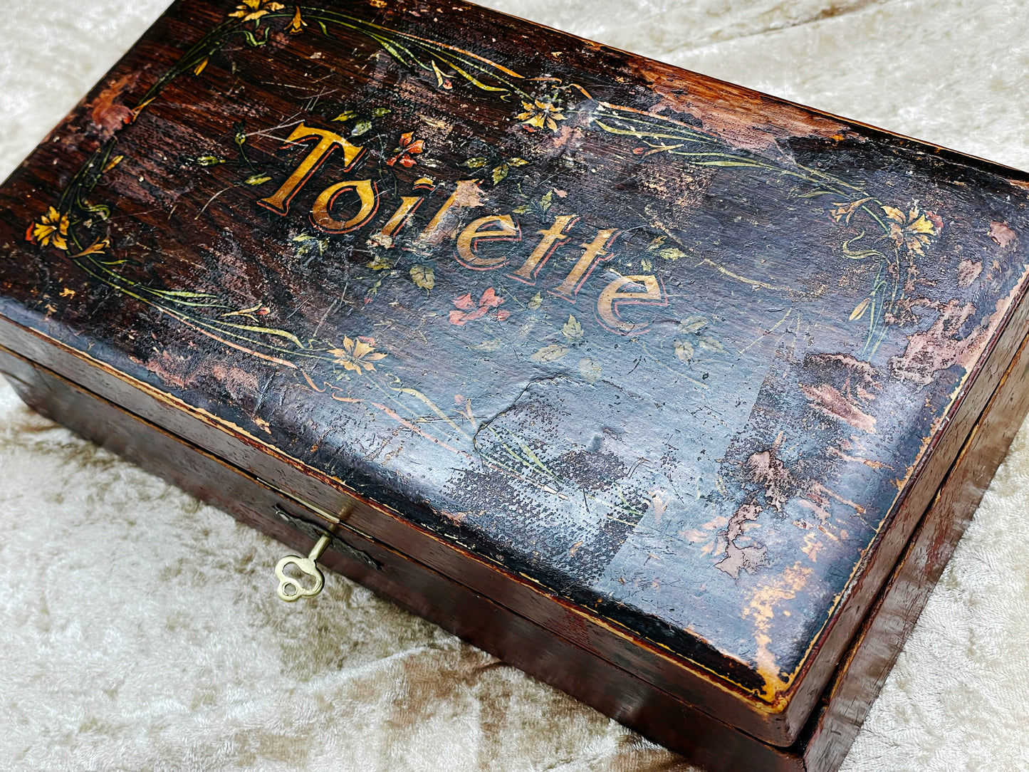Hand-painted Toilette box angled view highlighting patina and worn lid decoration
