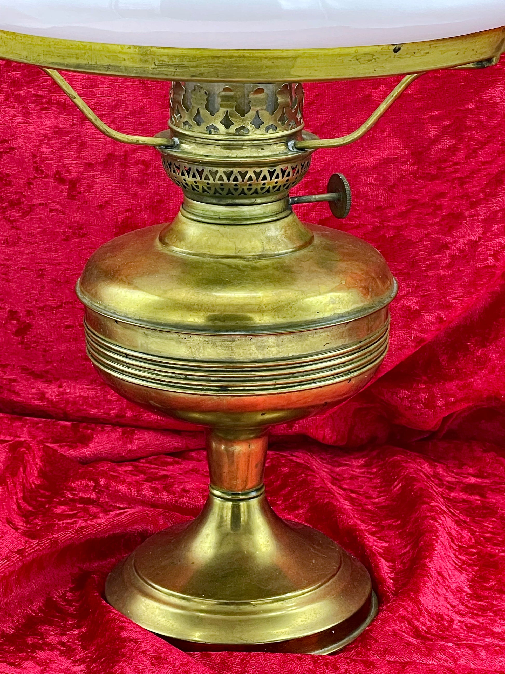 Close-up of the spun brass reservoir showing warm patina and reeded banding