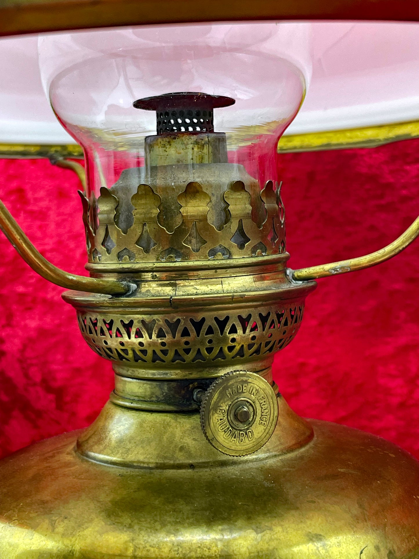 Detail of the pierced brass burner gallery with stamped maker's mark
