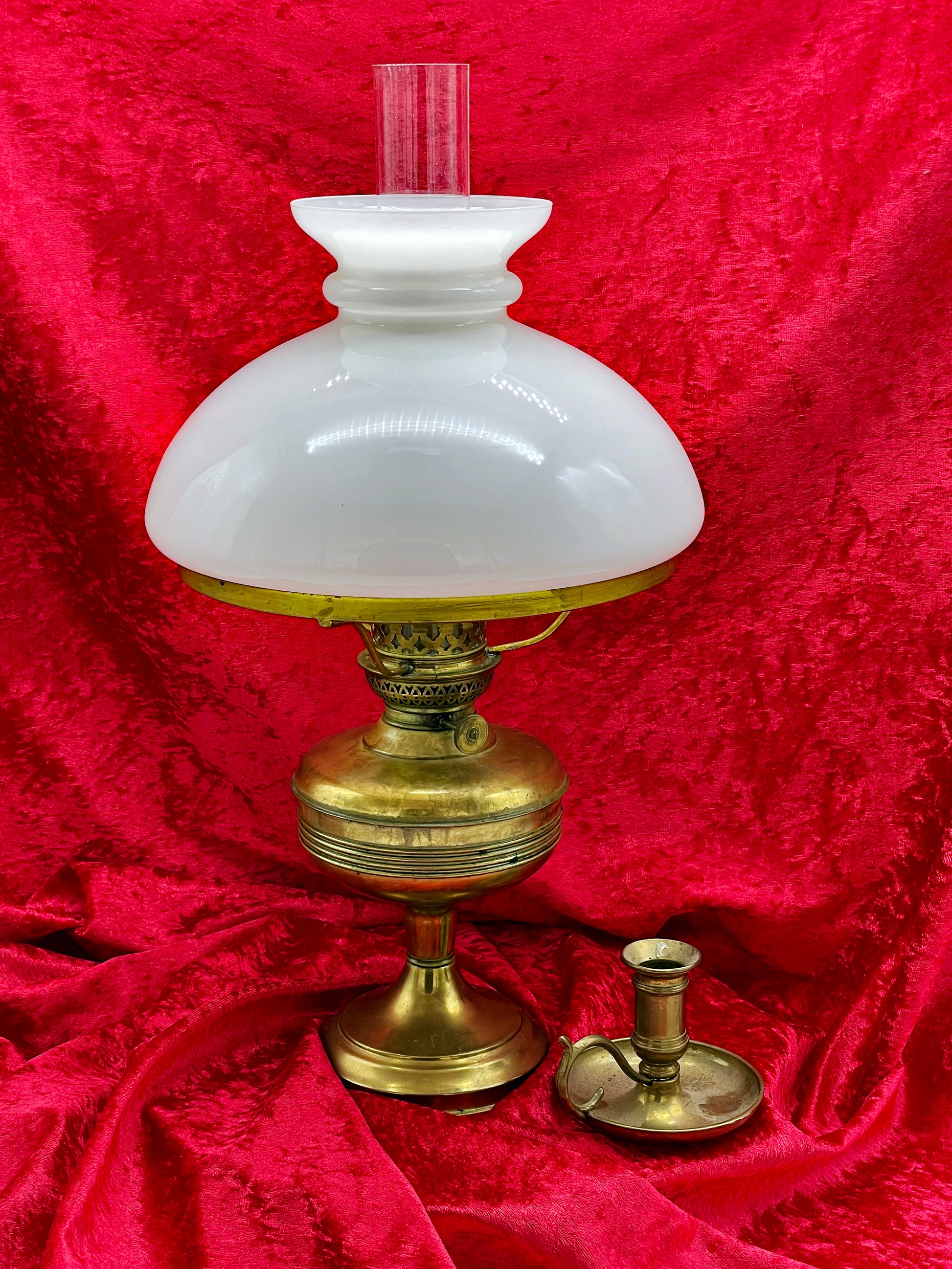 Brass oil lamp shown with companion brass chamberstick candle holder set