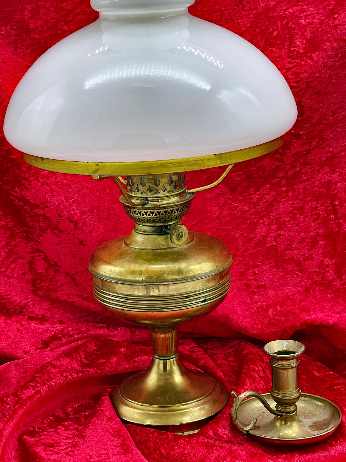 Lower view of the brass lamp reservoir beside the brass candle holder