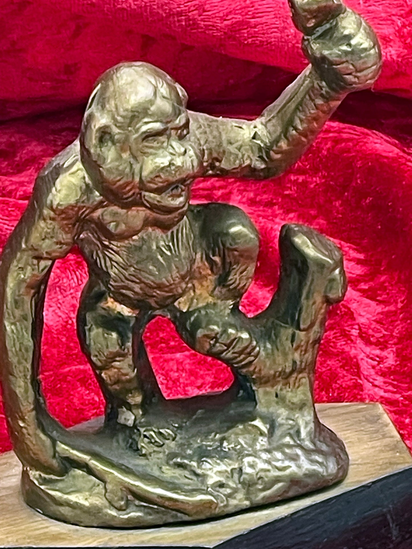 Bronze ape figure side detail showing modelled fur and muscular arm
