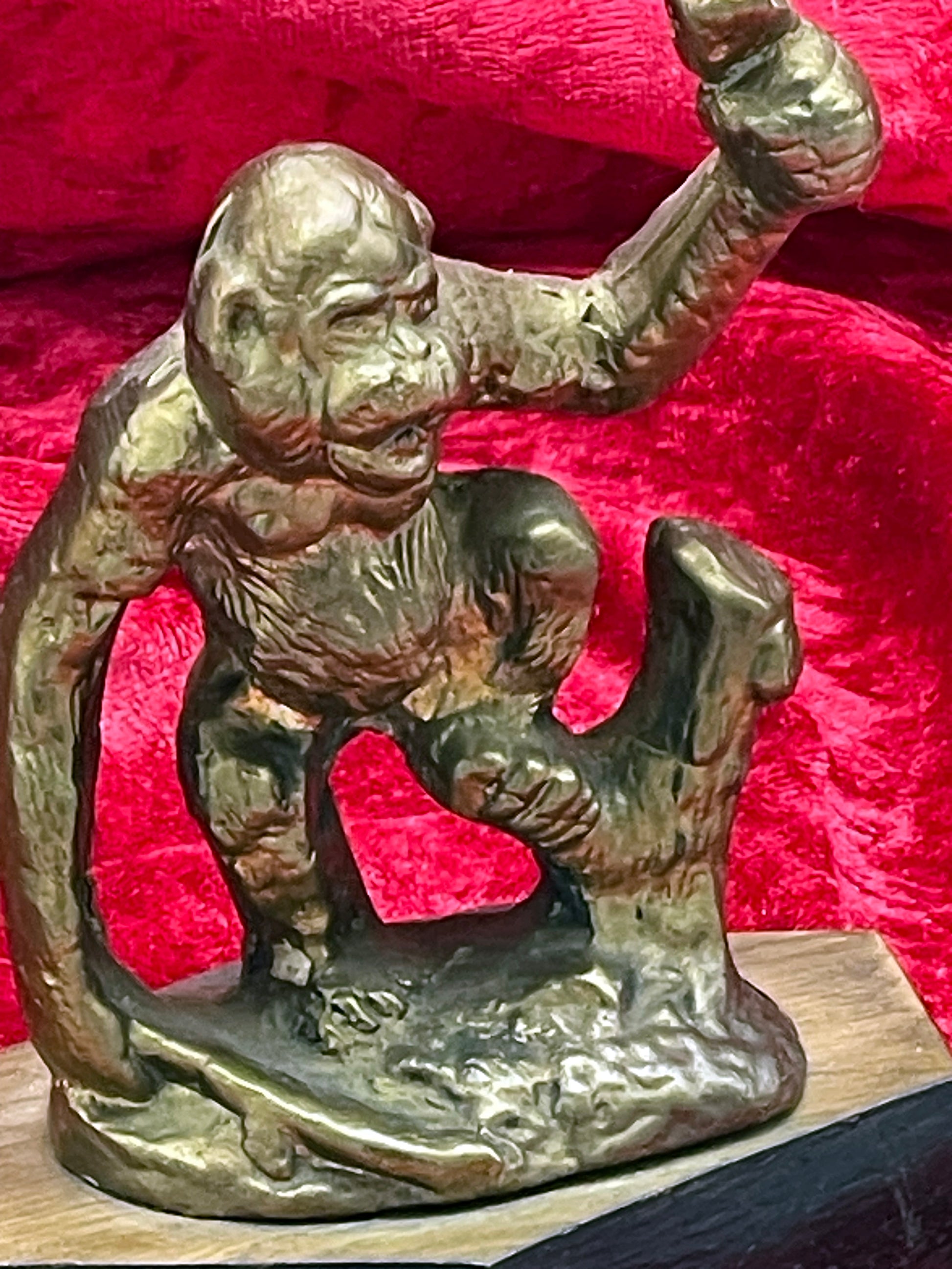 Bronze ape figure side detail showing modelled fur and muscular arm