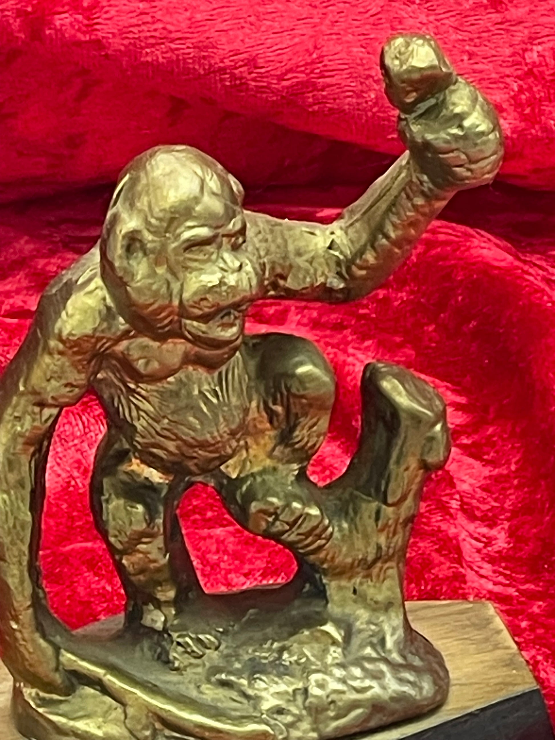 Close-up of bronze gorilla face and raised fist with fine surface texture
