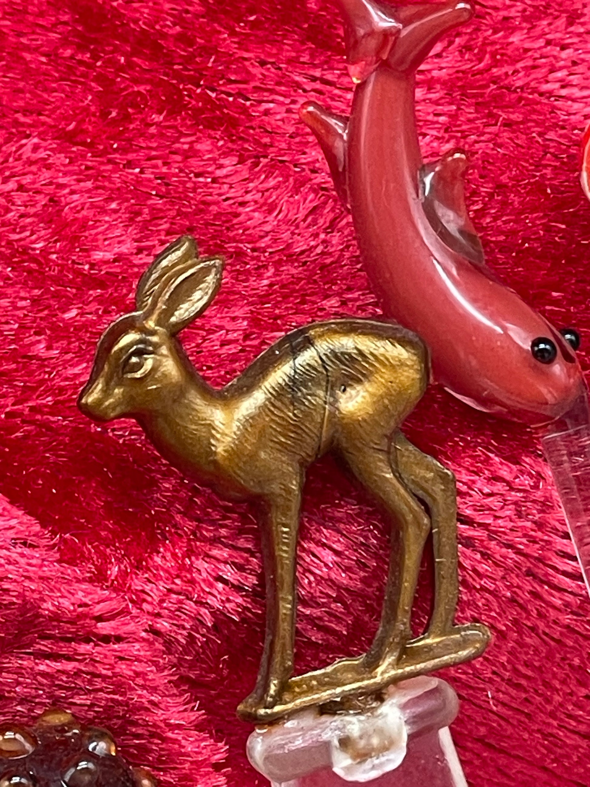 Detail of white hand-blown glass swan and colourful figural cocktail pick toppers