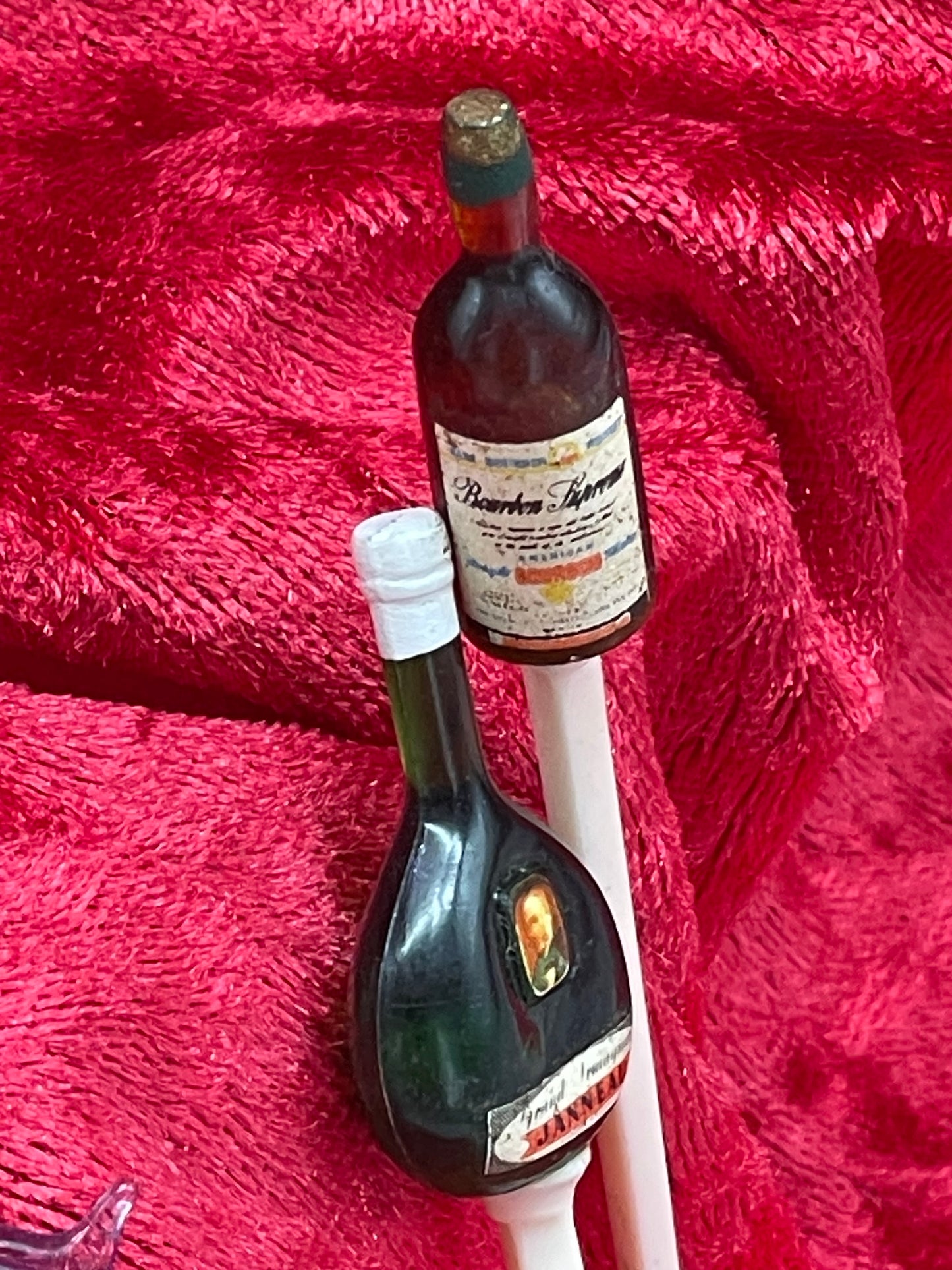 Two figural miniature liquor bottle cocktail picks with paper labels