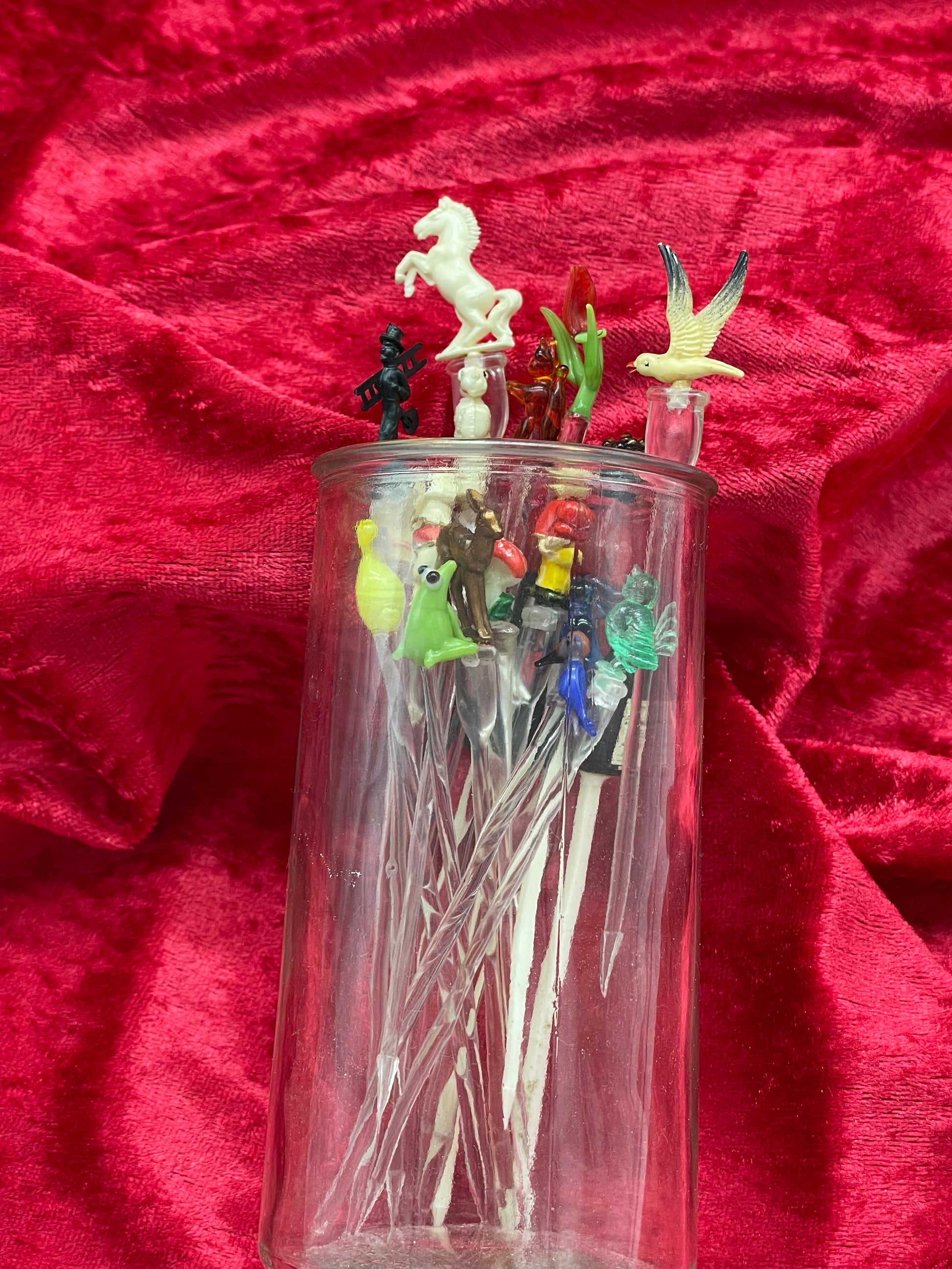 Cocktail picks collection displayed standing in a clear glass tumbler