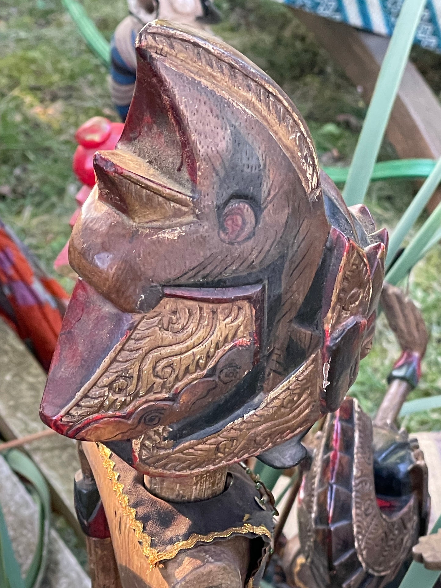 Close detail of hand-carved Garuda style bird head on a Javanese rod puppet
