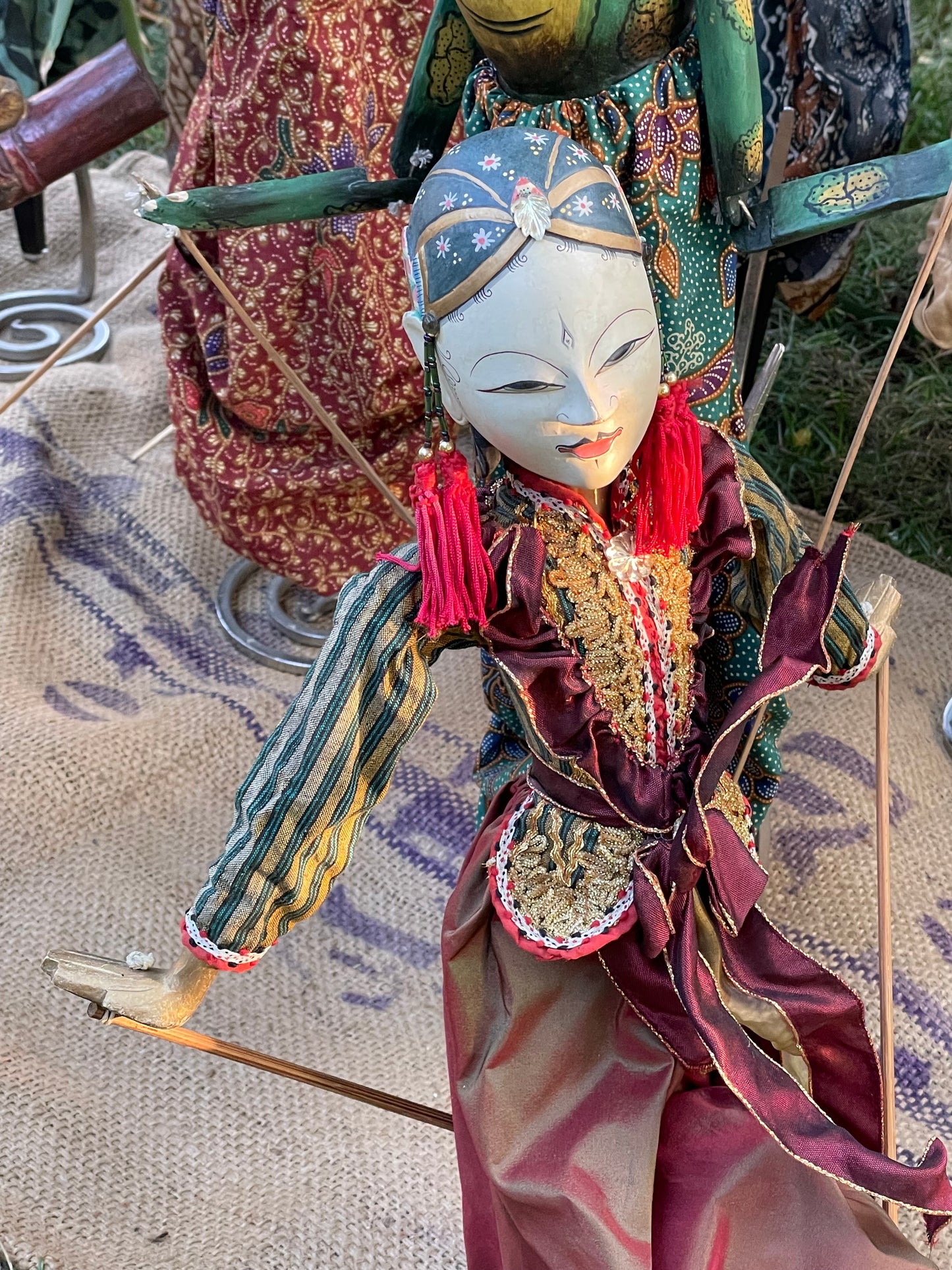 Antique Javanese Wayang Golek rod puppet with carved white face and batik costume