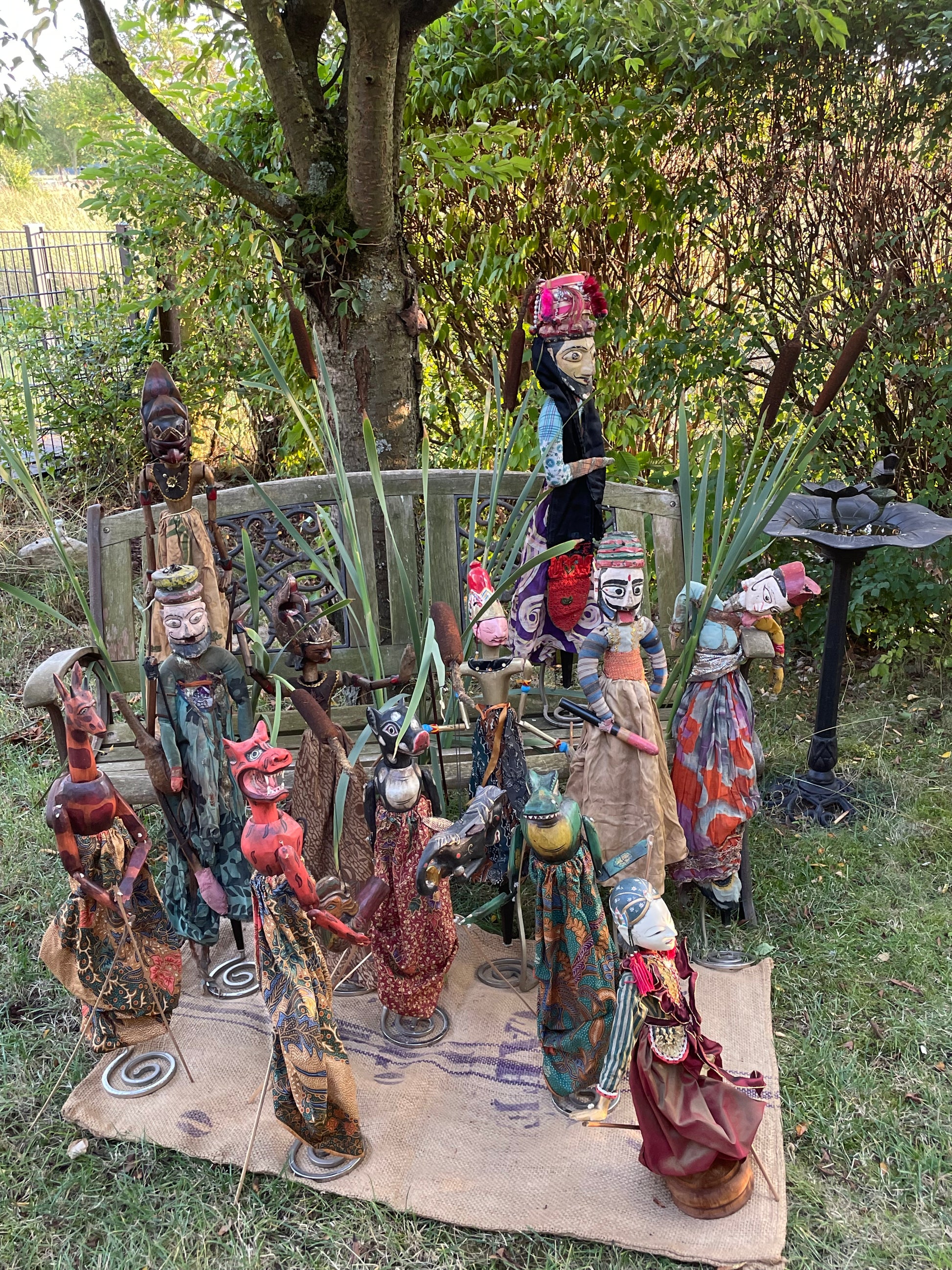 Collection of antique Javanese Wayang Golek puppets displayed together as a group