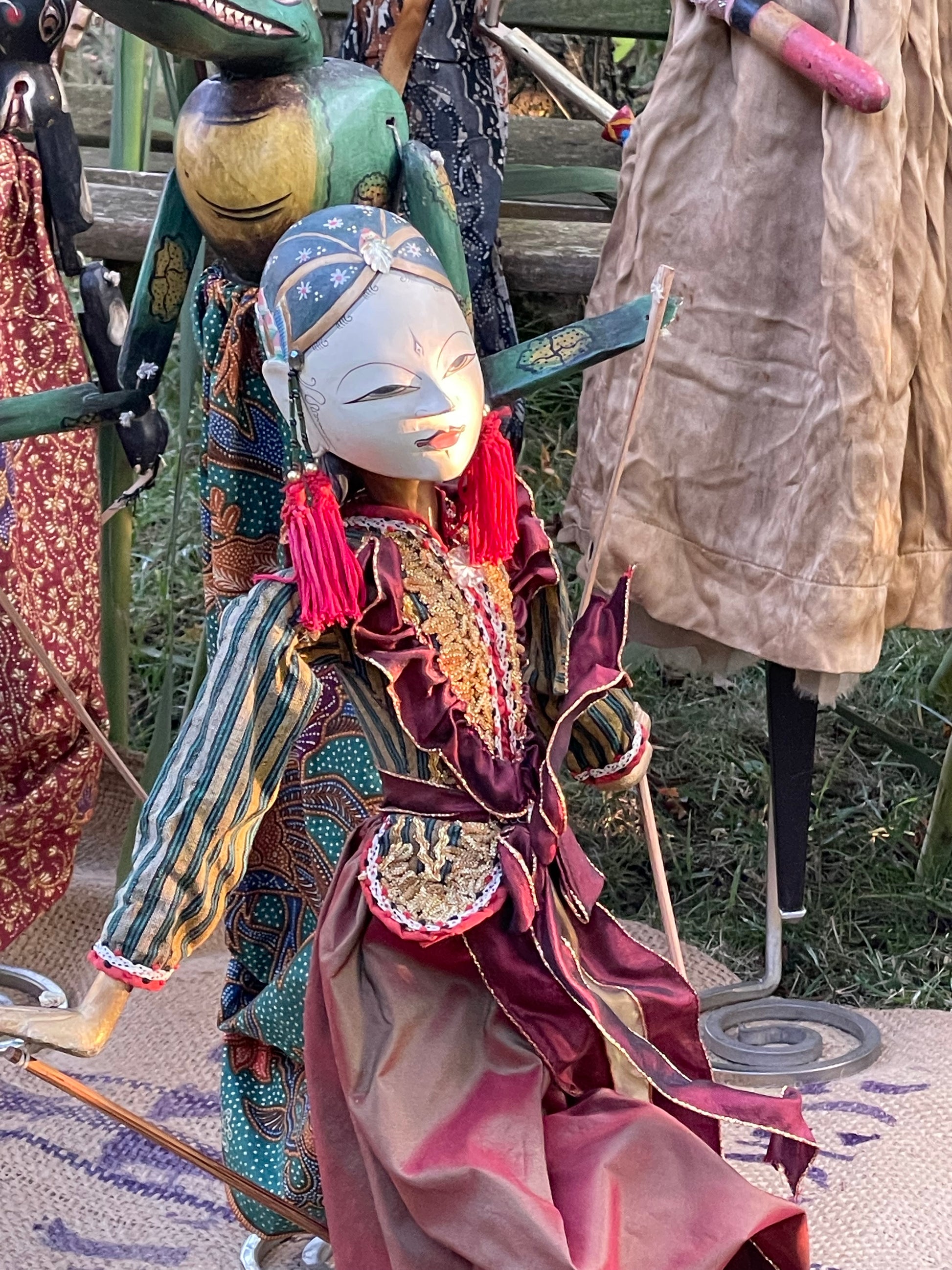 Hand-carved noble Wayang Golek puppet with refined painted face and silk robes