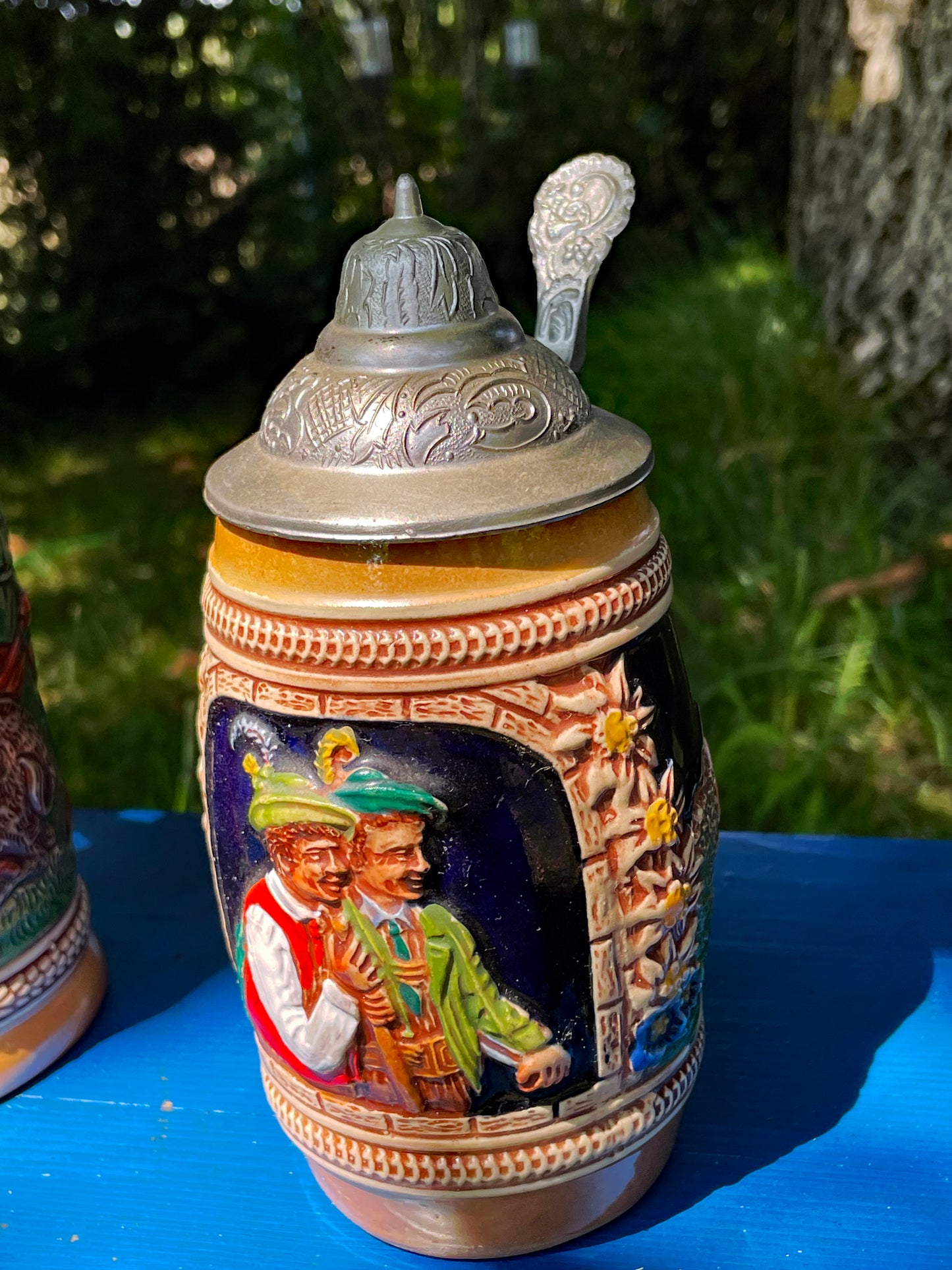 Barrel-form German stein with hand-painted Bavarian folk figures and pewter lid