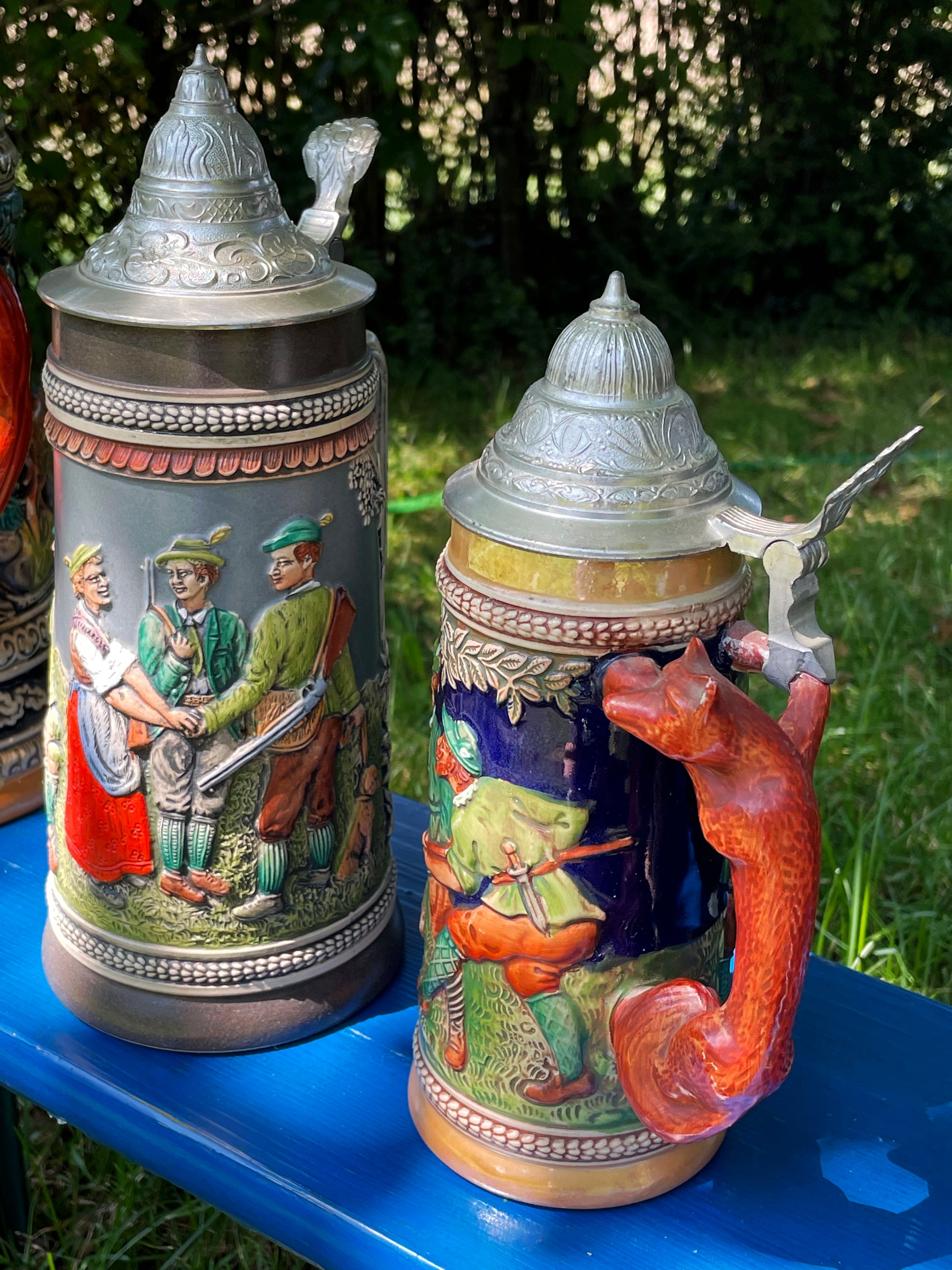 Charming ceramic squirrel-form handle detail on one of the steins
