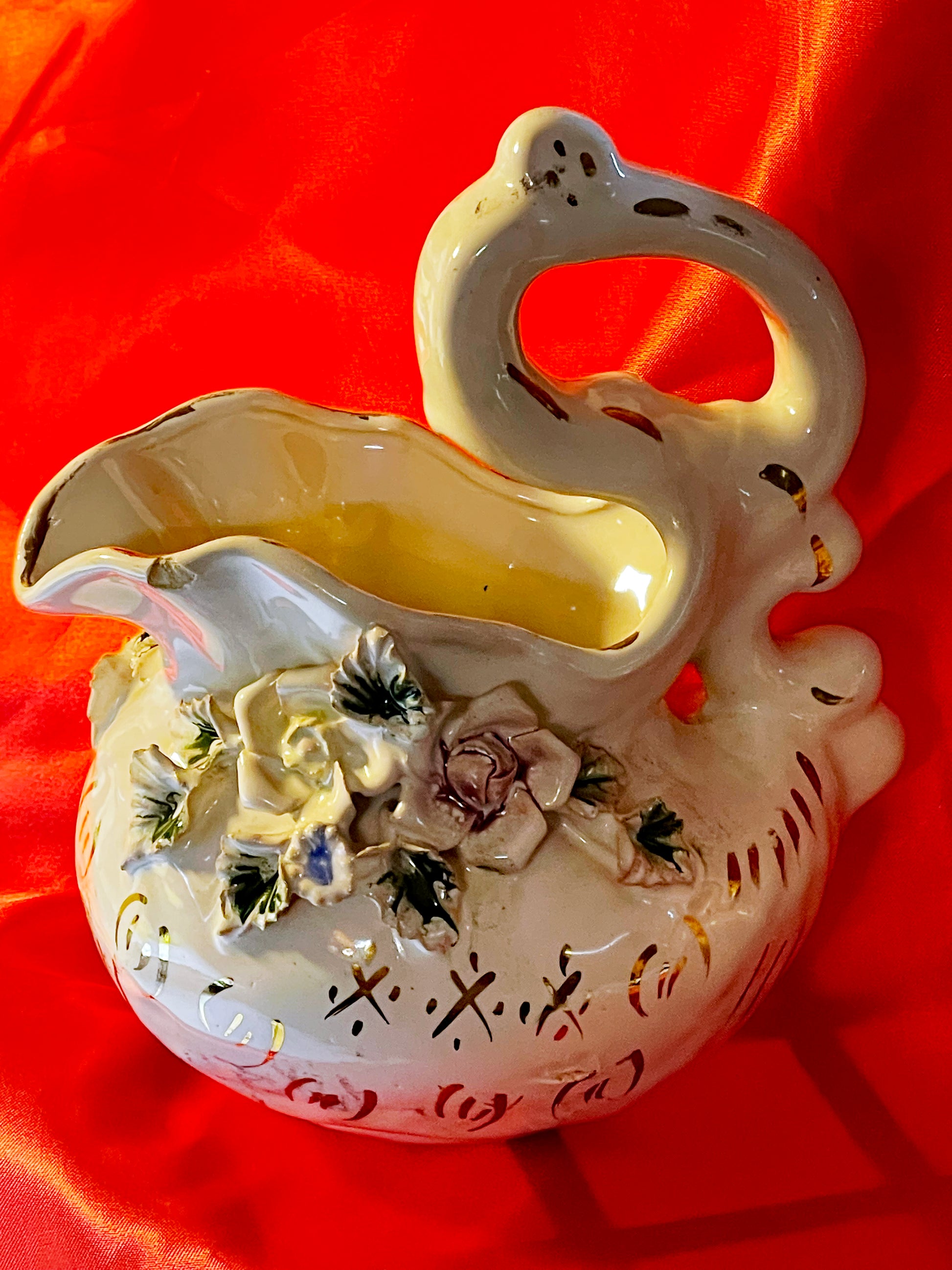 Porcelain ewer or jug with swan shaped handle and applied roses