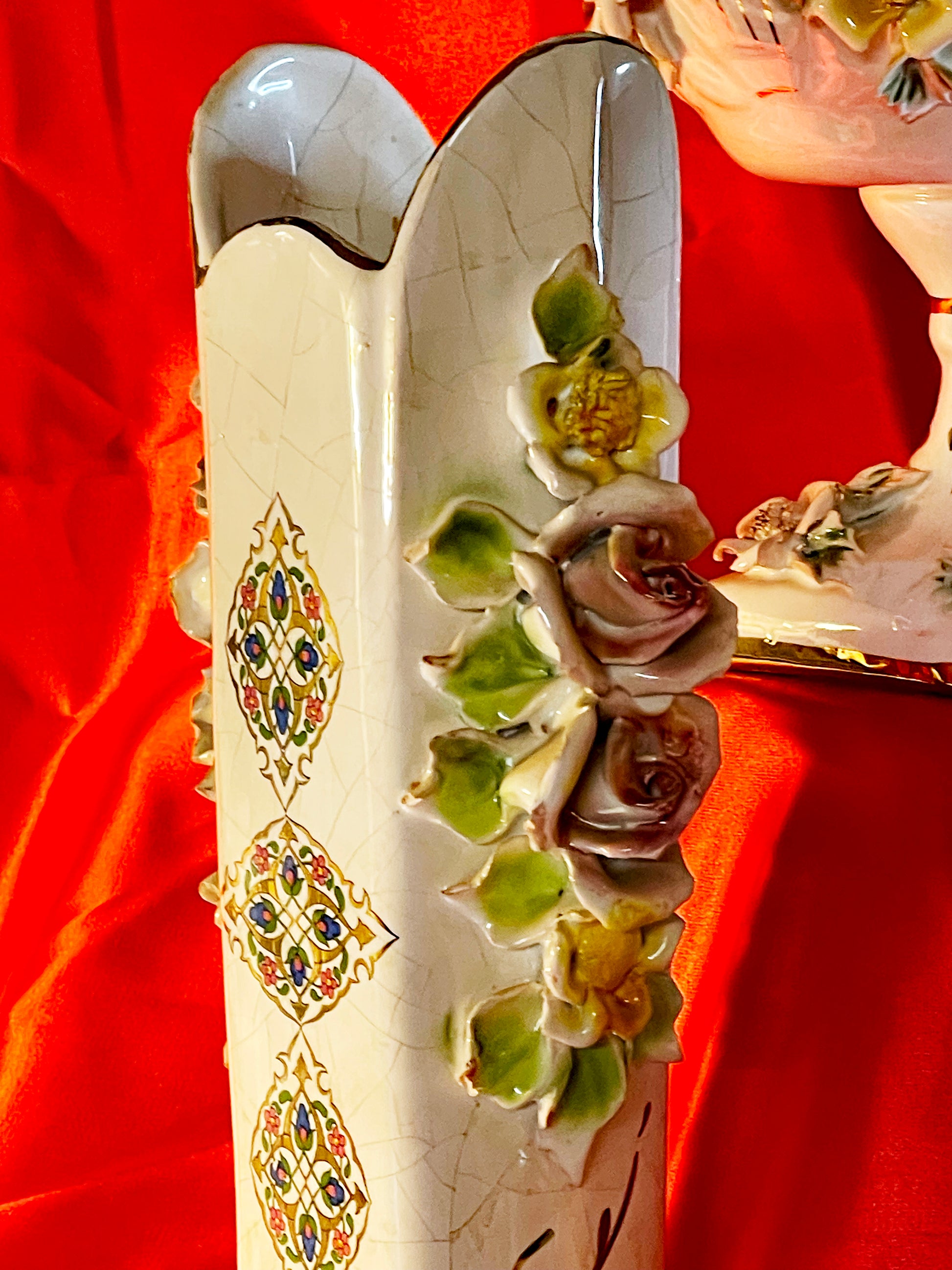 Lidded porcelain trinket box with applied flowers and gilt handle on feet