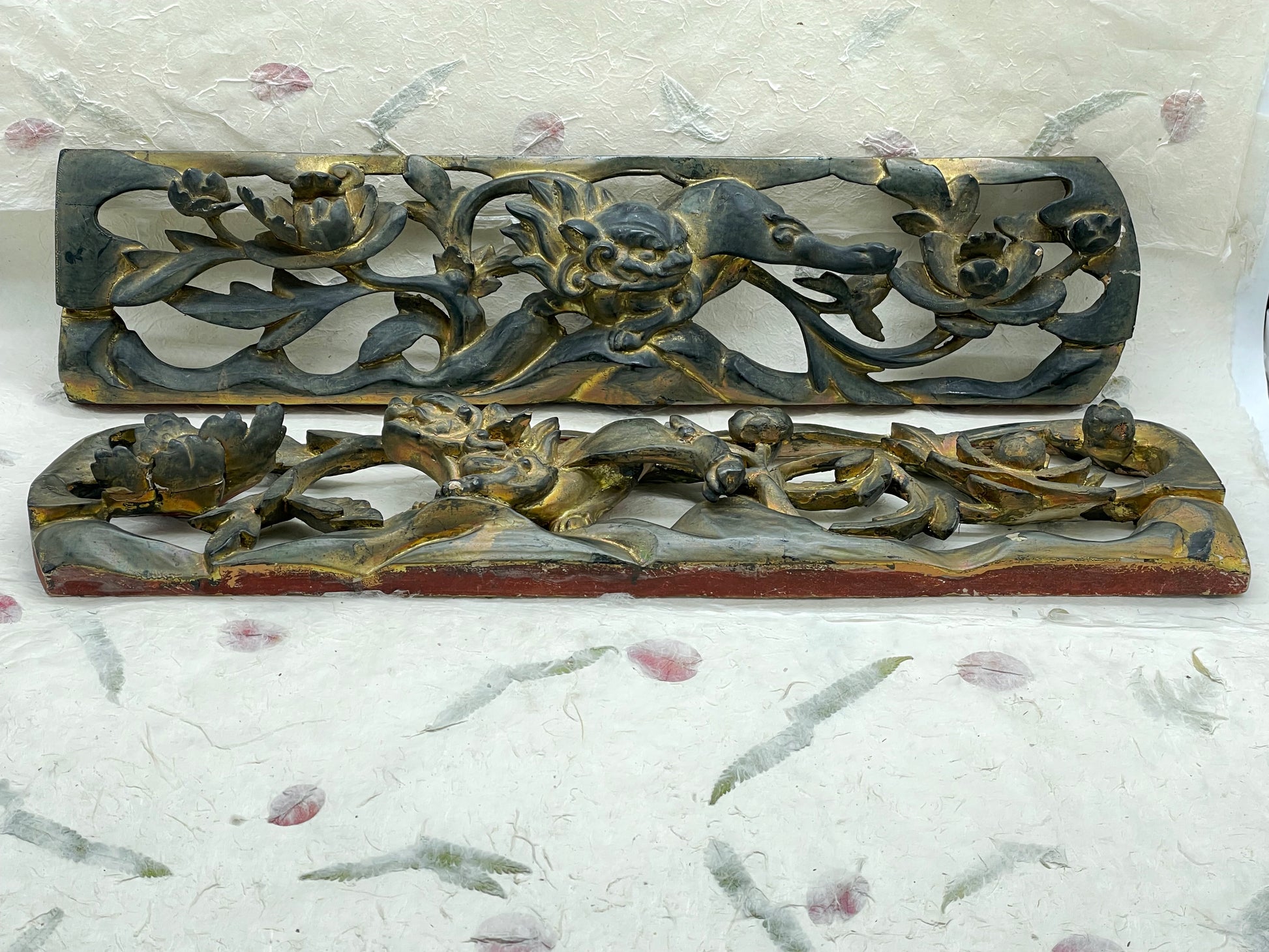 Carved floral and vine motifs on antique Chinese wood panel