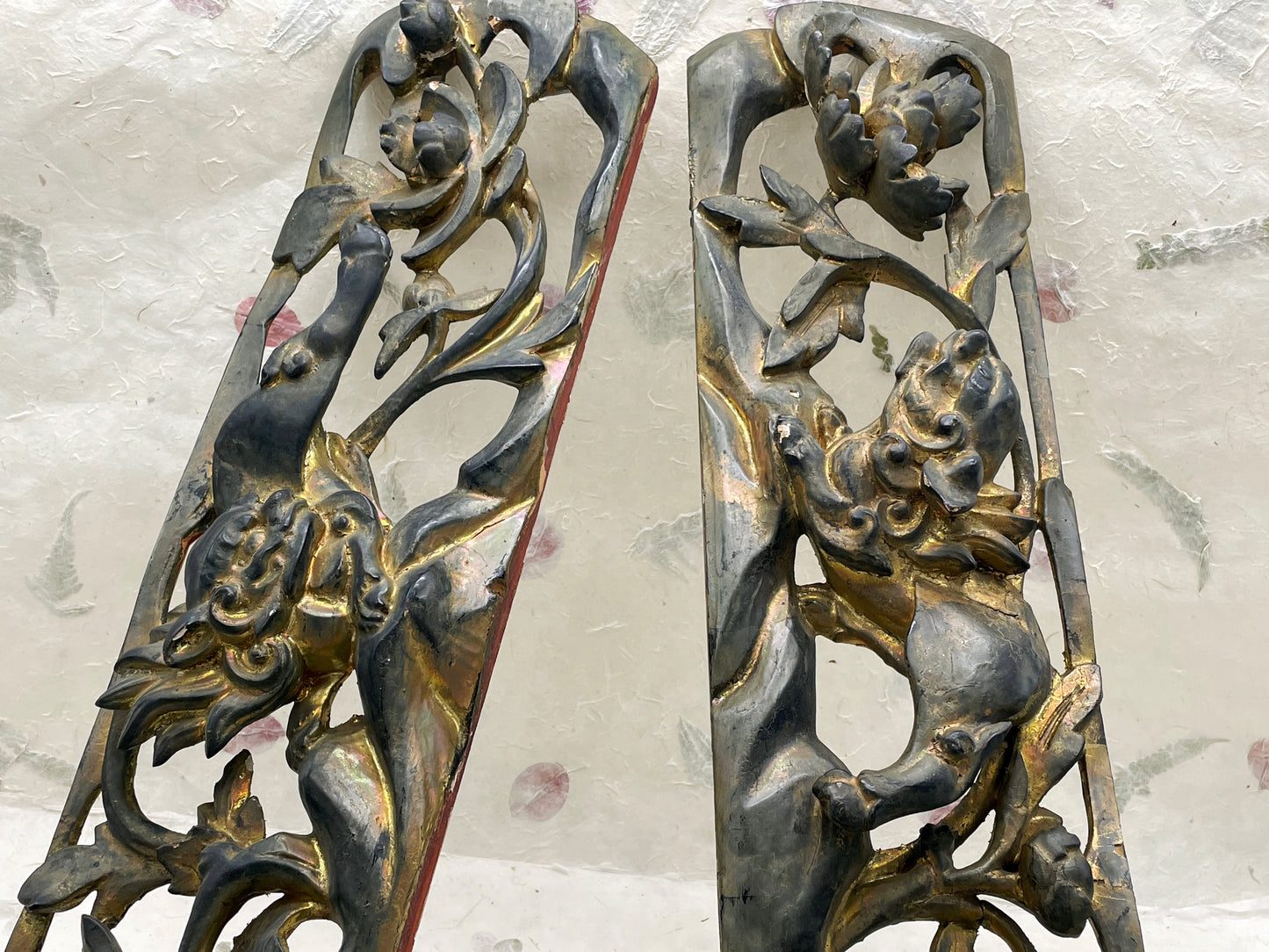Pair of antique Chinese carved giltwood panels with lion and floral relief