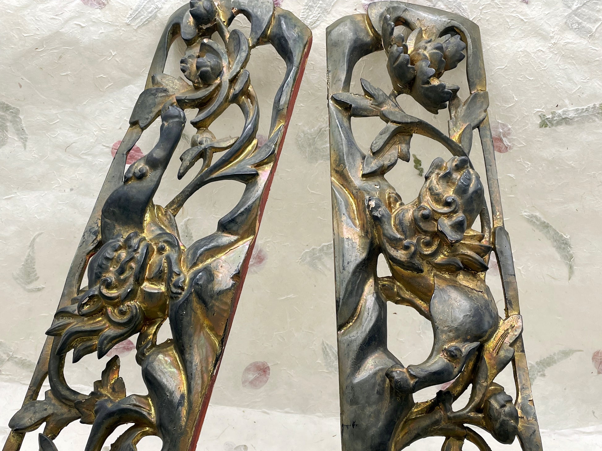 Pair of antique Chinese carved giltwood panels with lion and floral relief