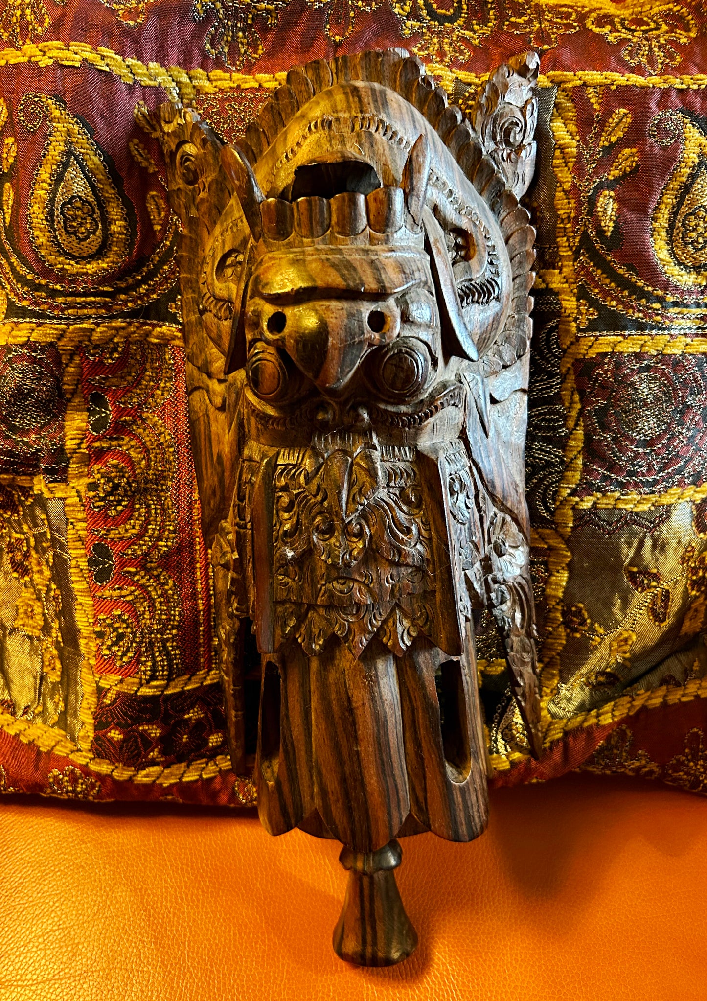 Balinese Garuda wood sculpture shown at a three-quarter angle revealing carved wing