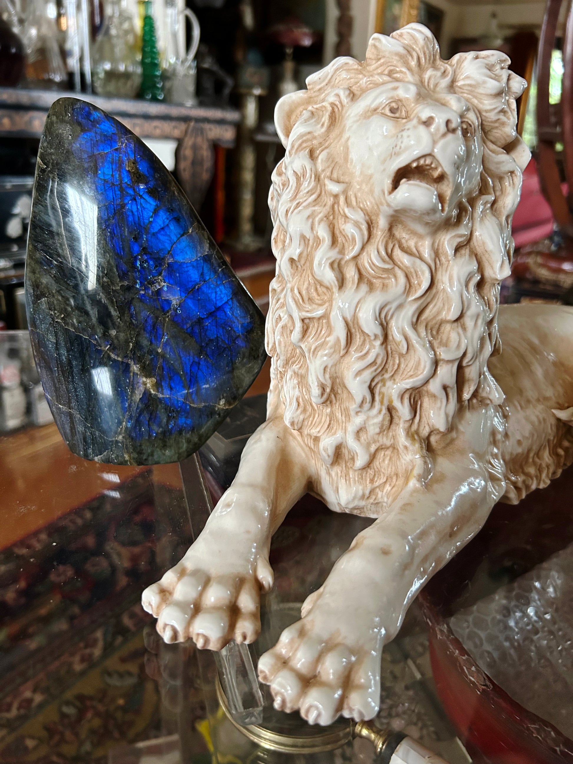 Close detail of the porcelain lion's hand-decorated mane and roaring head