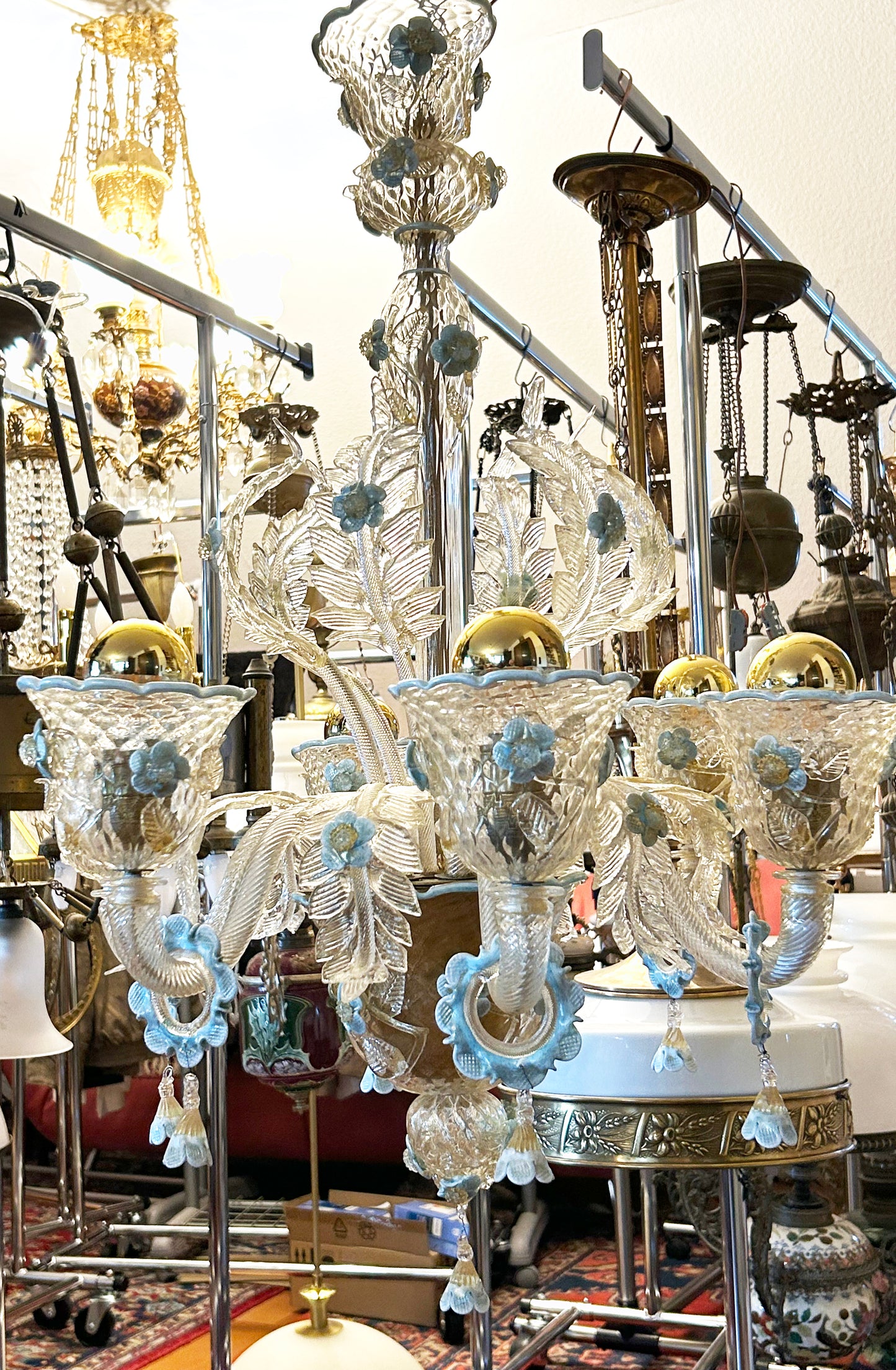 Murano chandelier full view with crown, sculpted leaves and blue glass flowers