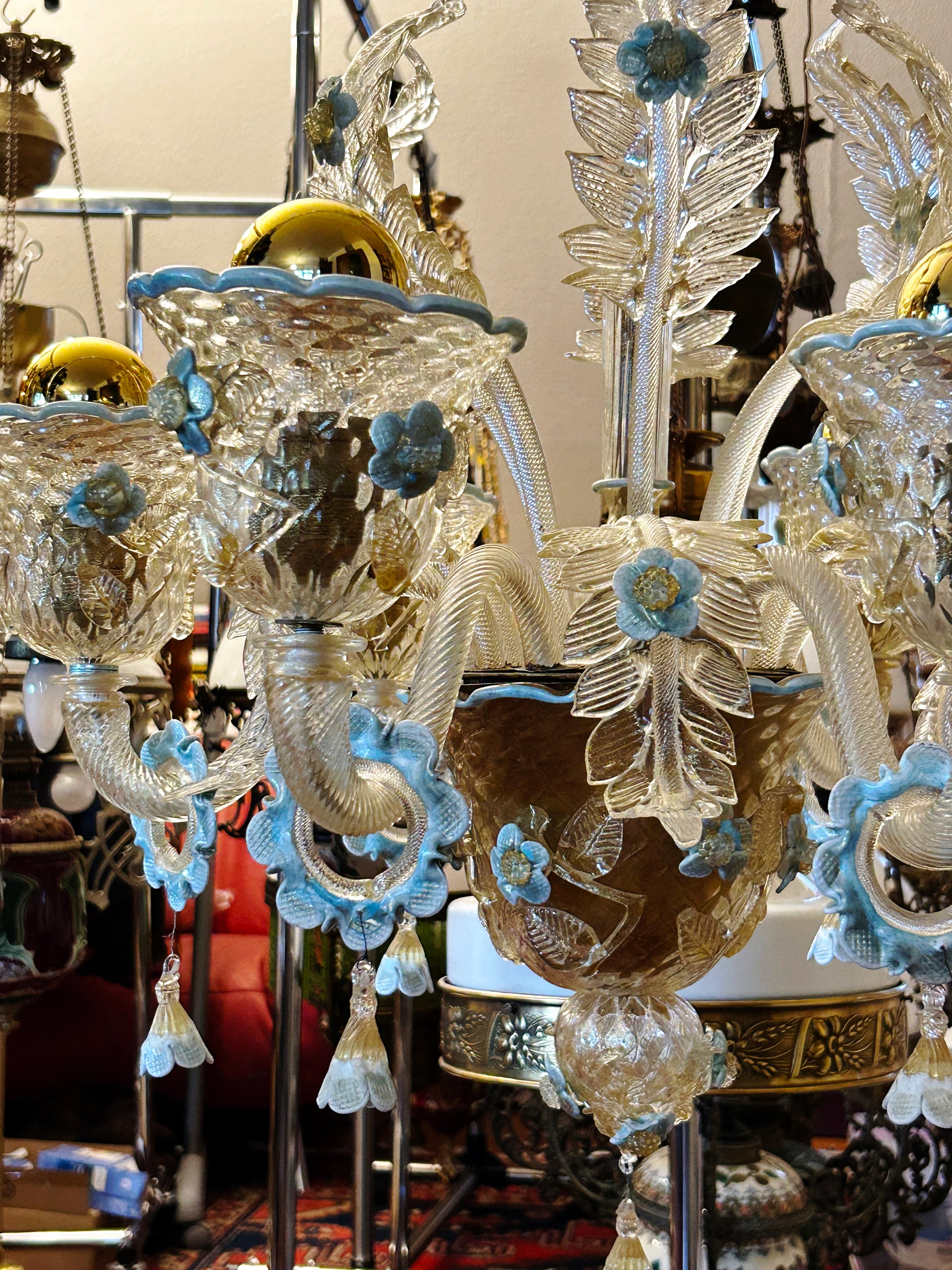 Detail of Murano chandelier arms with white twisted glass and blue flowers