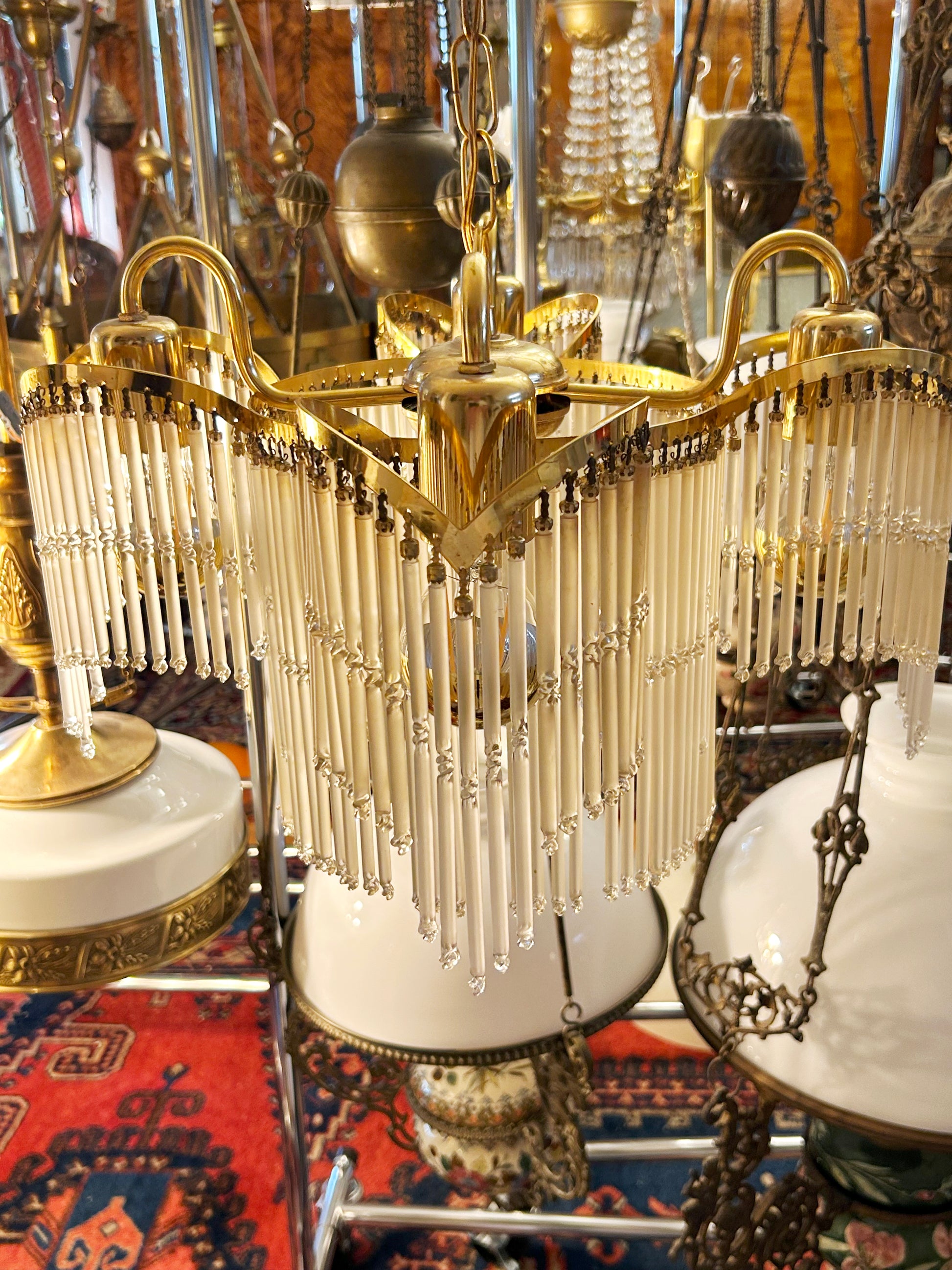 Detail of the gilt-brass crown and swan-neck arms at the top of the chandelier