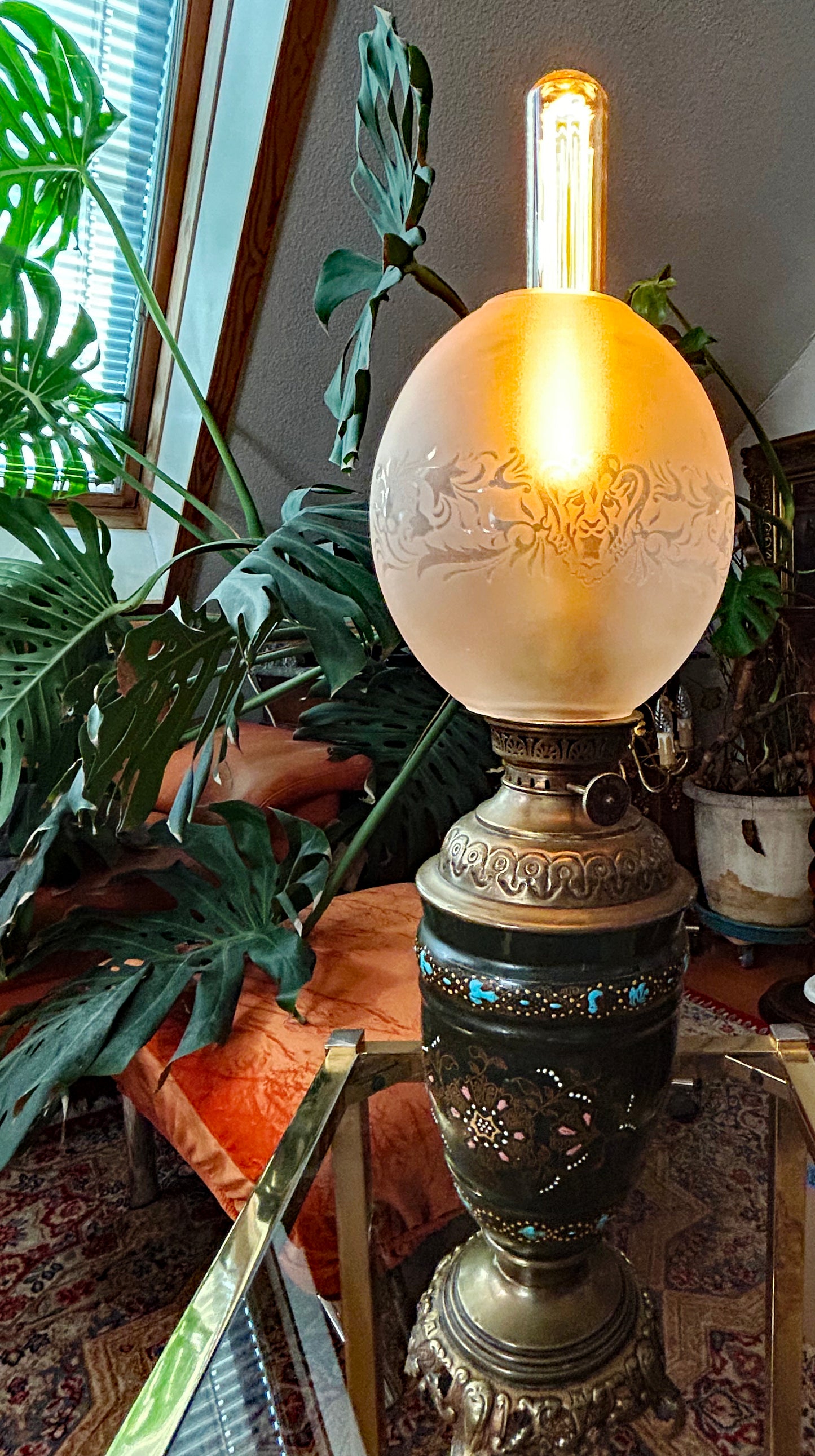 Cloisonné enamel petroleum lamp illuminated, warm glowing etched glass globe