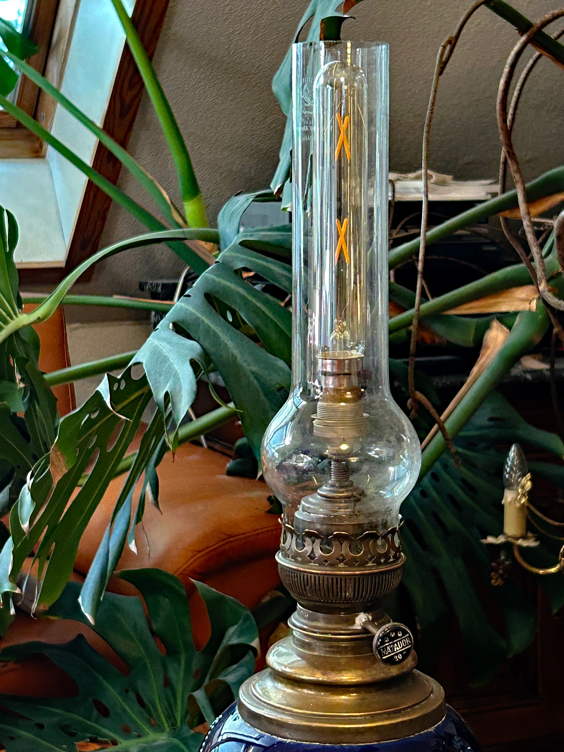 Brass burner and clear glass chimney of the electrified petroleum lamp