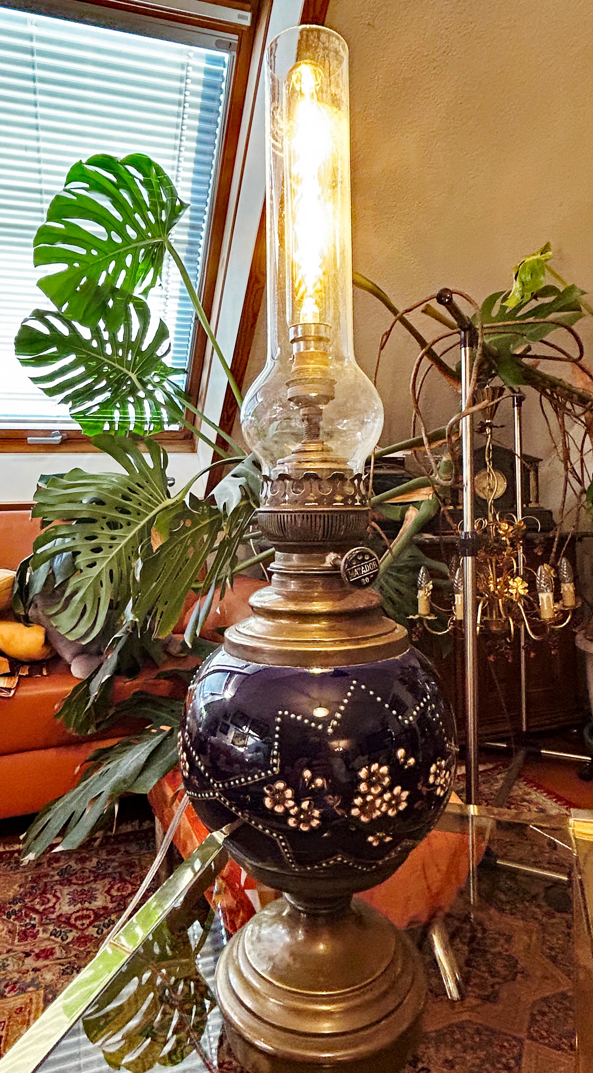 Full view of antique Chinese cloisonné table lamp with brass foot and glass chimney