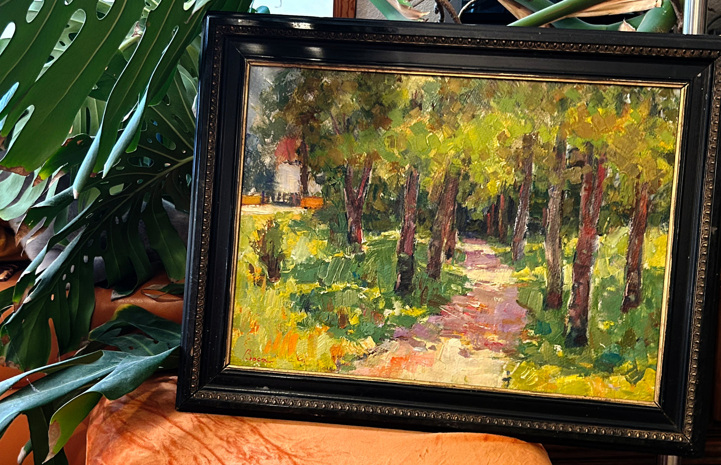 Three-quarter angle of the Ștefan Boca landscape painting showing impasto texture and frame depth