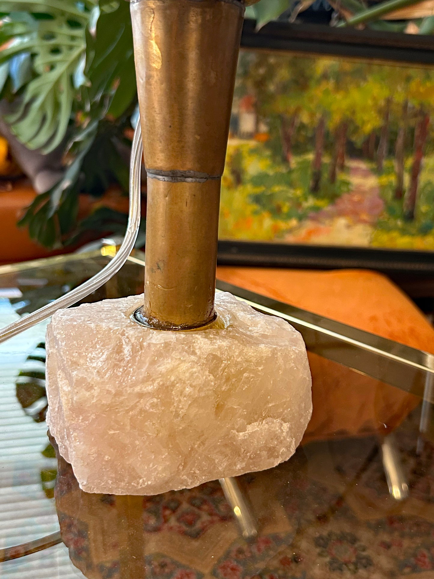Detail of the natural raw rose quartz crystal base and brass stem
